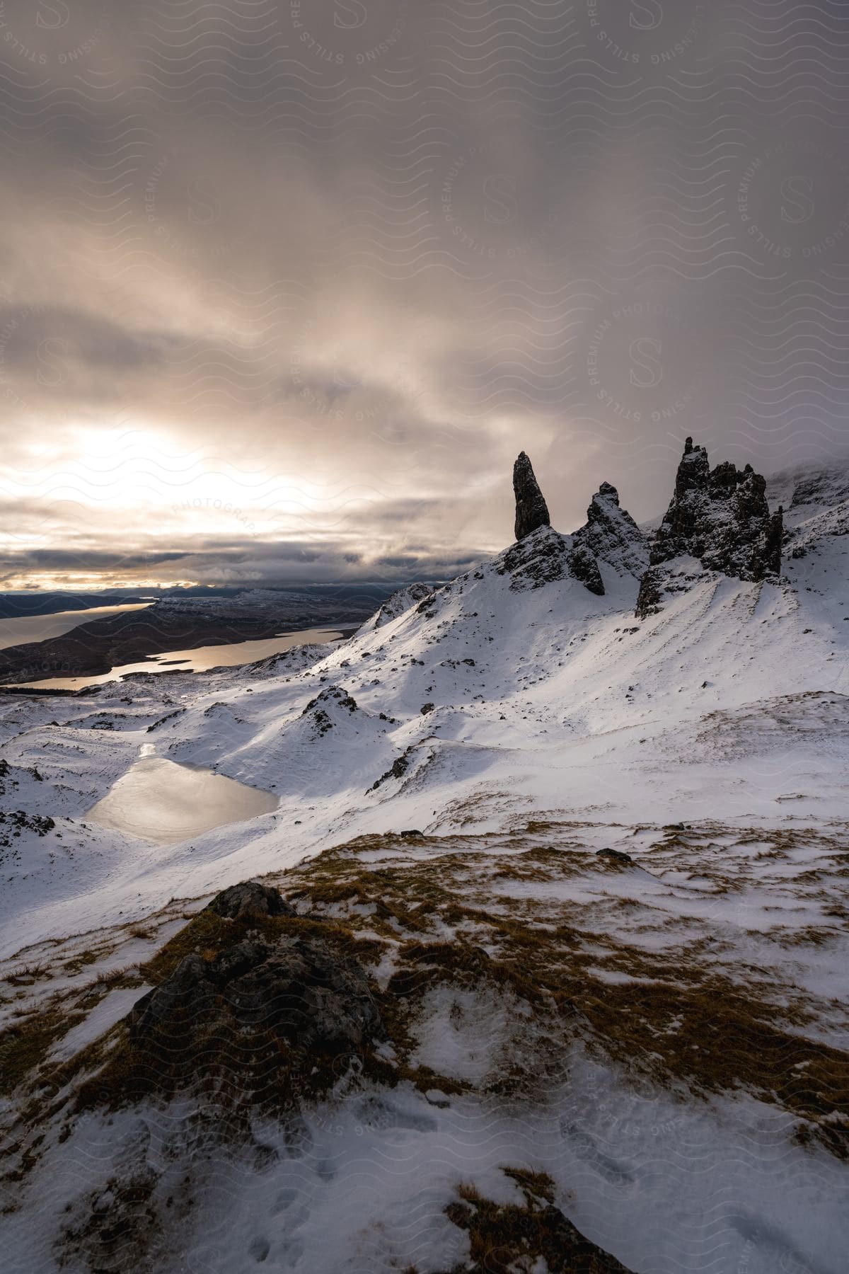 Dark clouds rolling across snowcovered mountain peaks in scotland