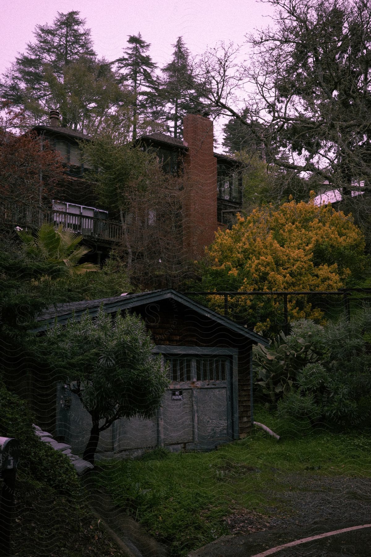 A building surrounded by flowers and trees in the countryside