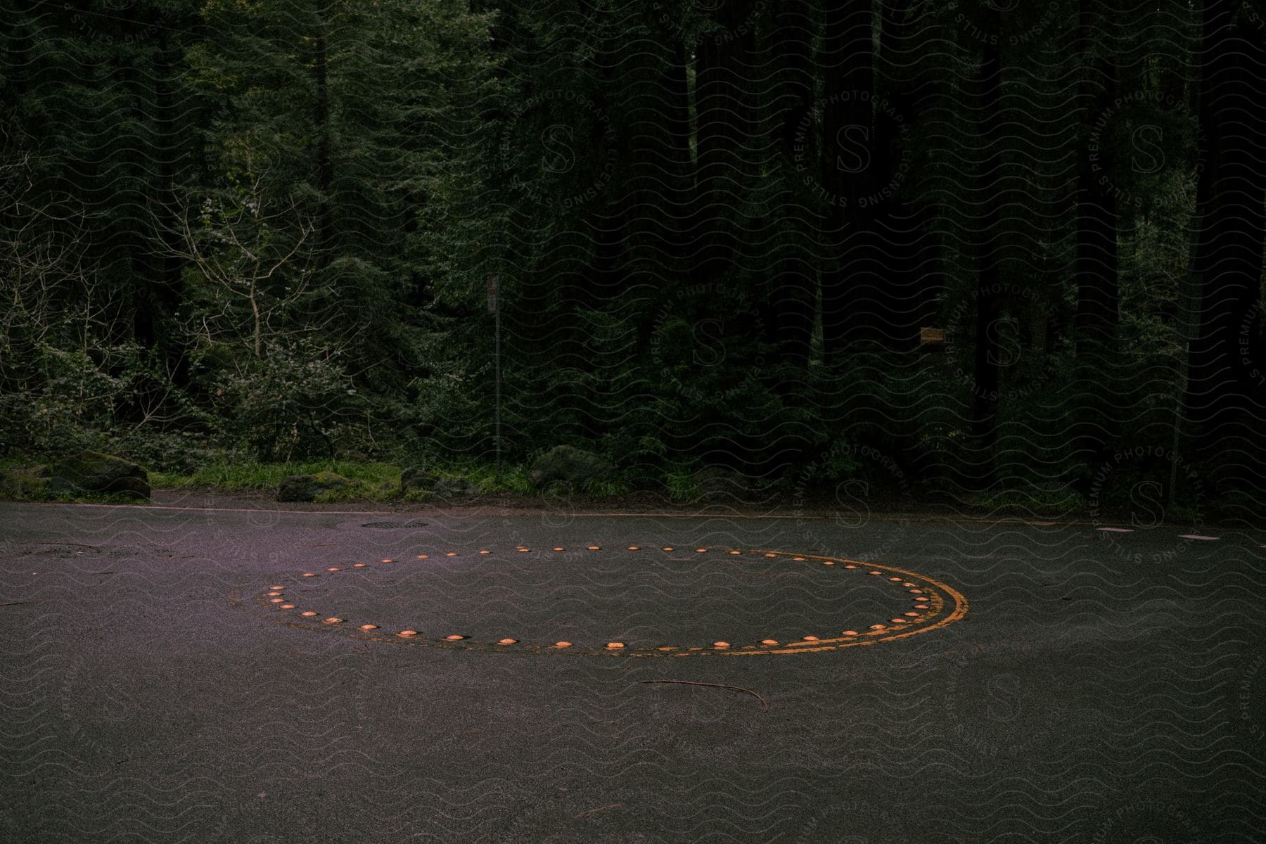 A wide road with a reflection of light at night