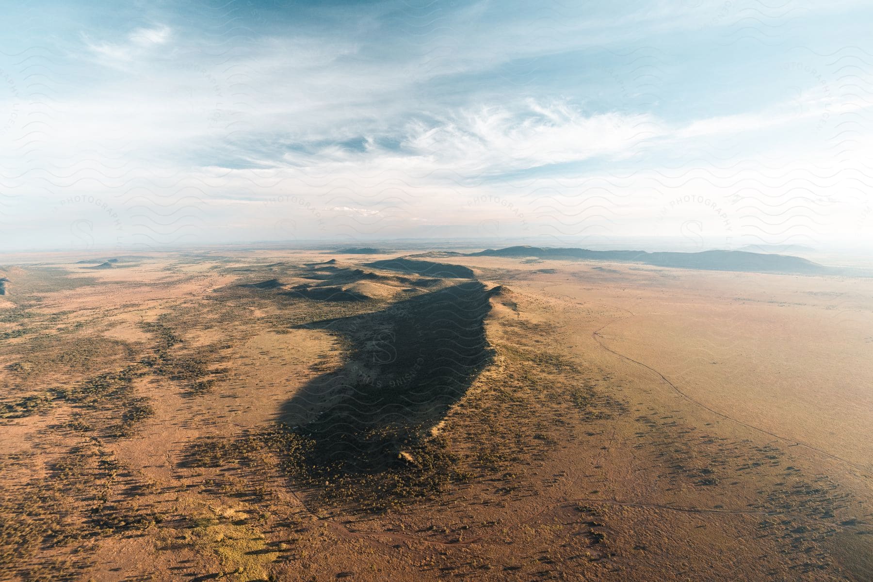 Plains and small hills are visible from the air