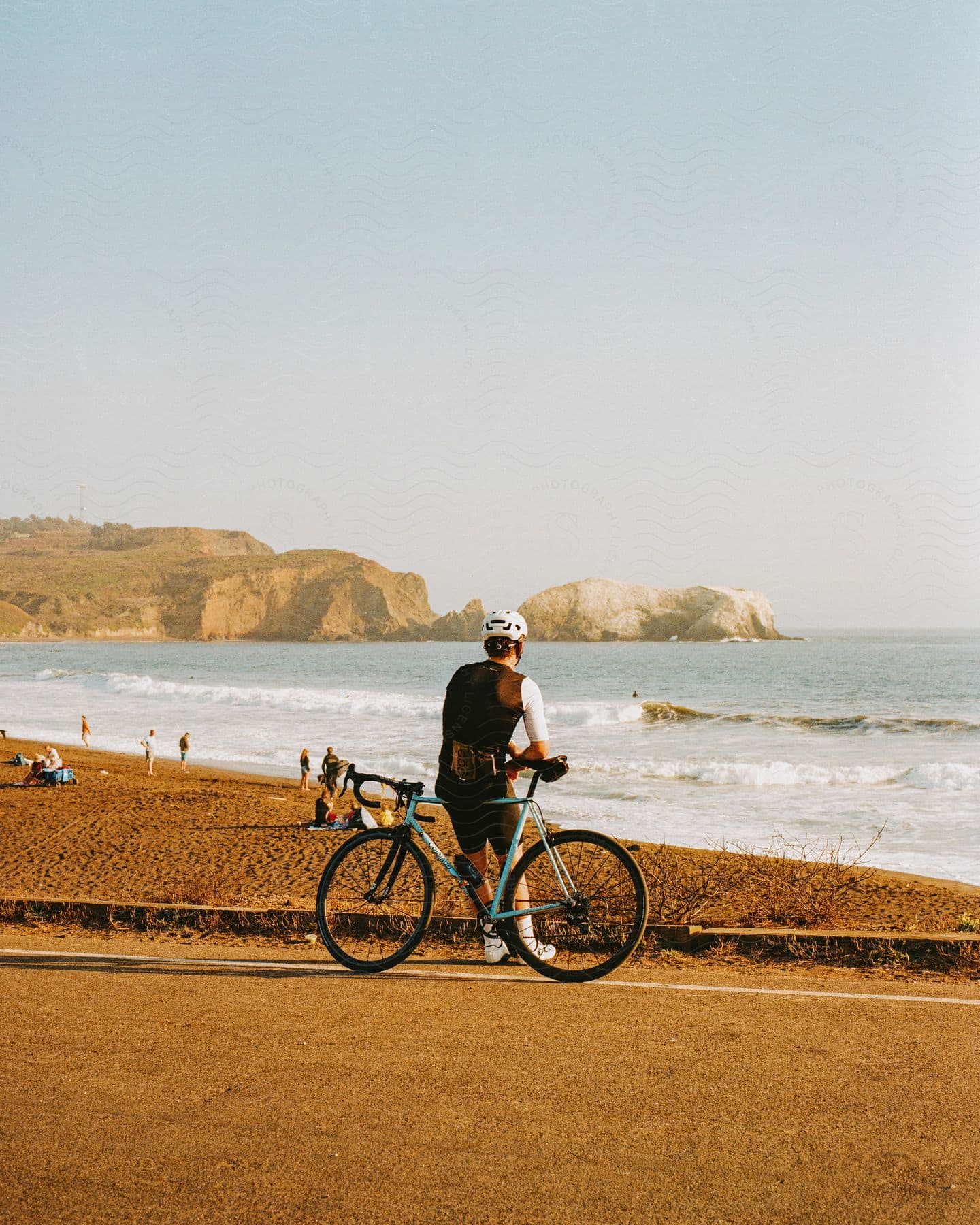 A man standing by the beach on a sunny day