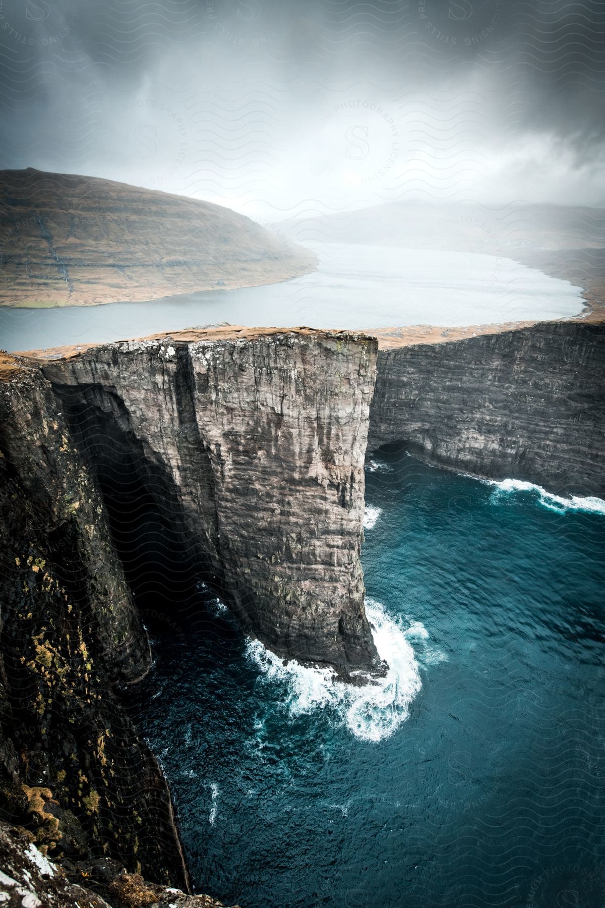 Mountainous landscape under cloudy skies in the faroe islands