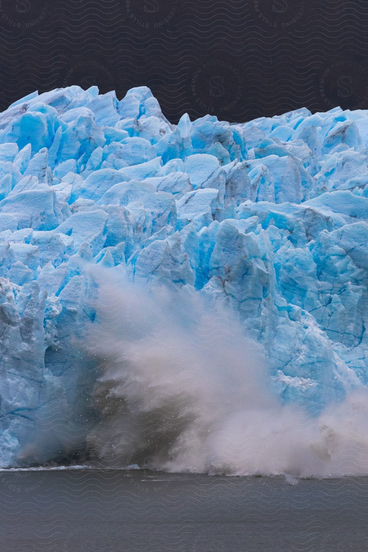 Iceberg crashing into the ocean in patagonia chile and argentina