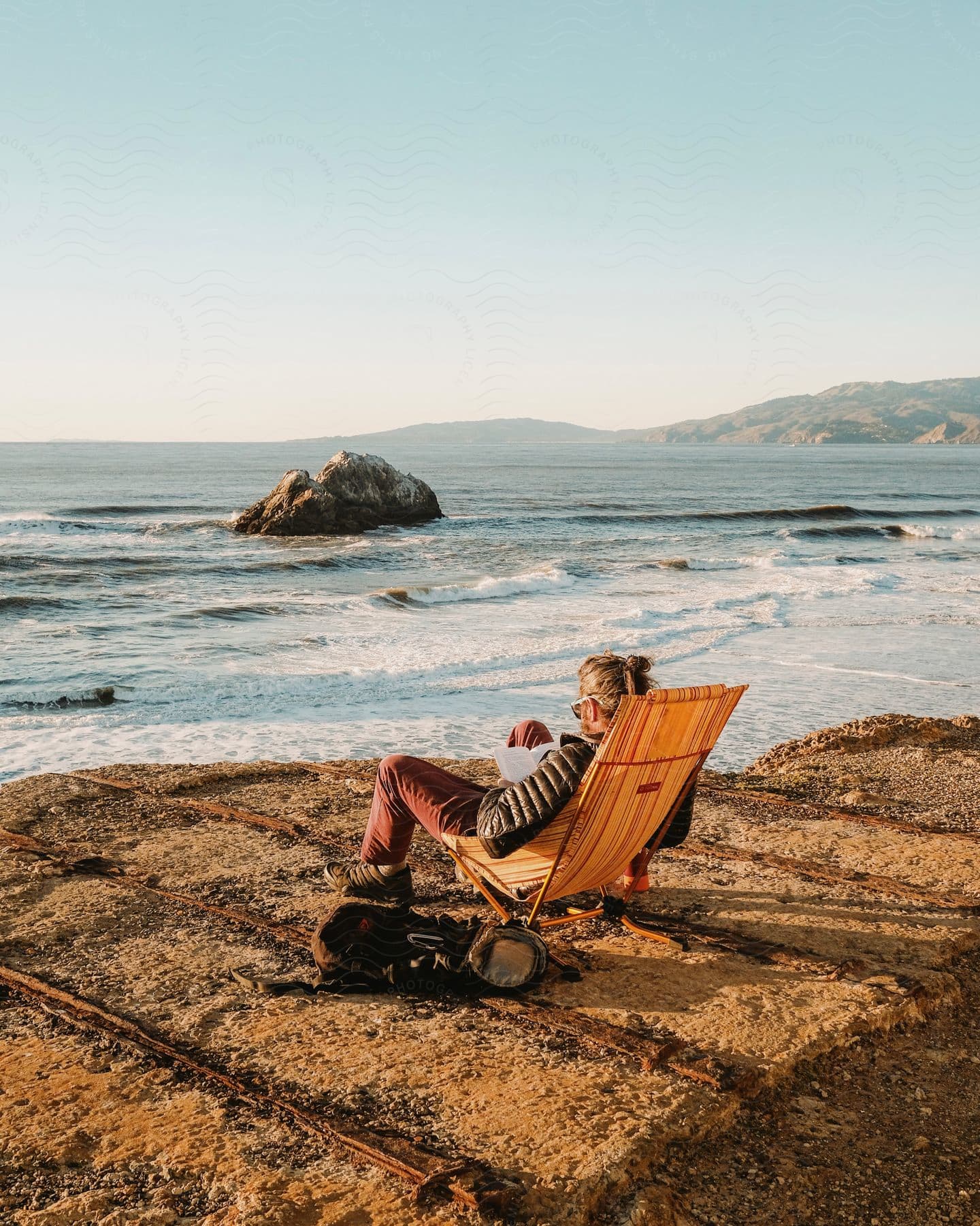 A person sitting by the riverside