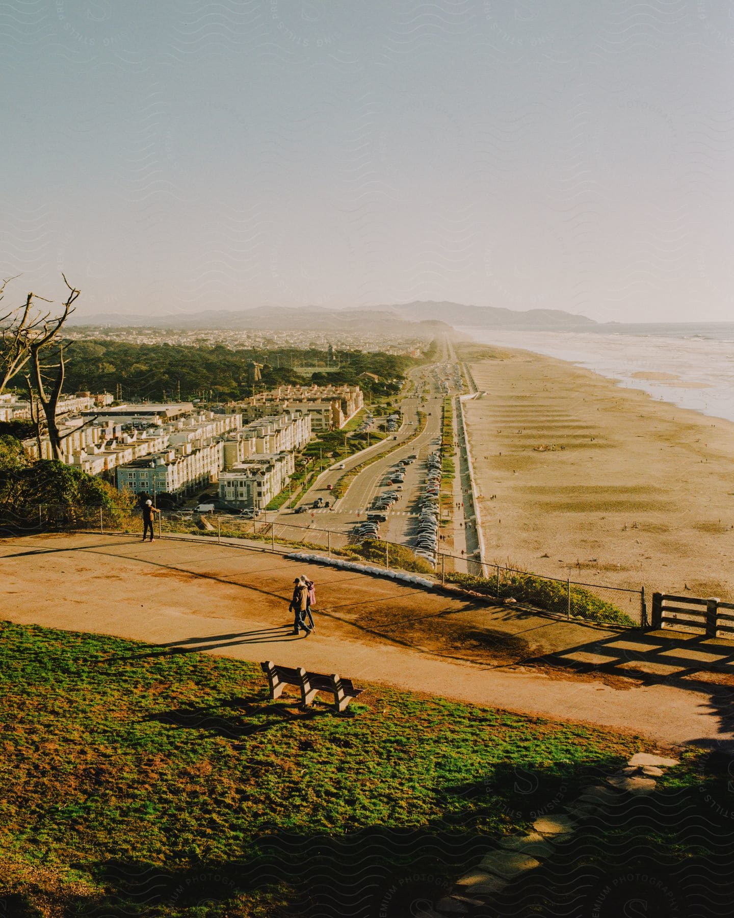 Coastal city and long wide beach seen from a hill