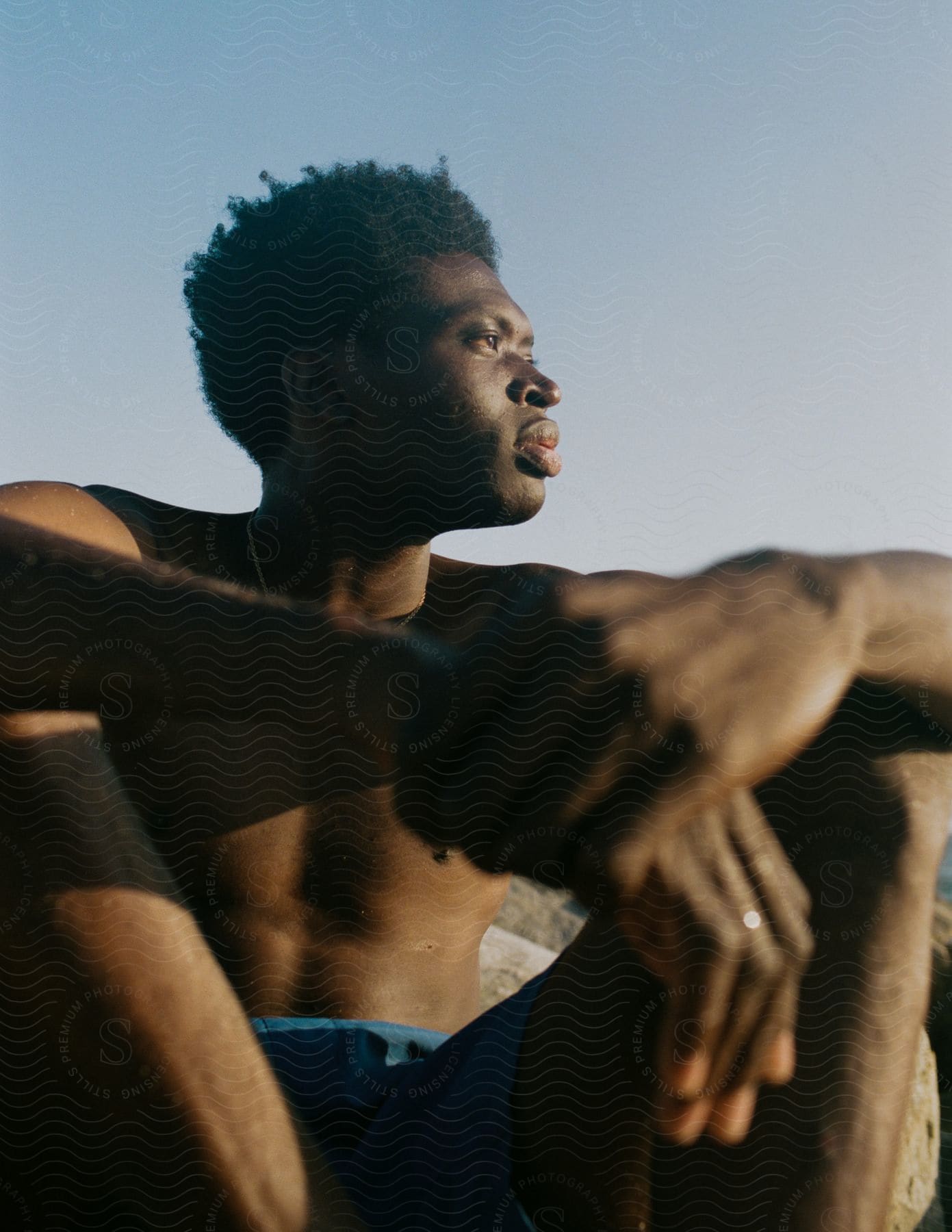 A man sitting outdoors during midday