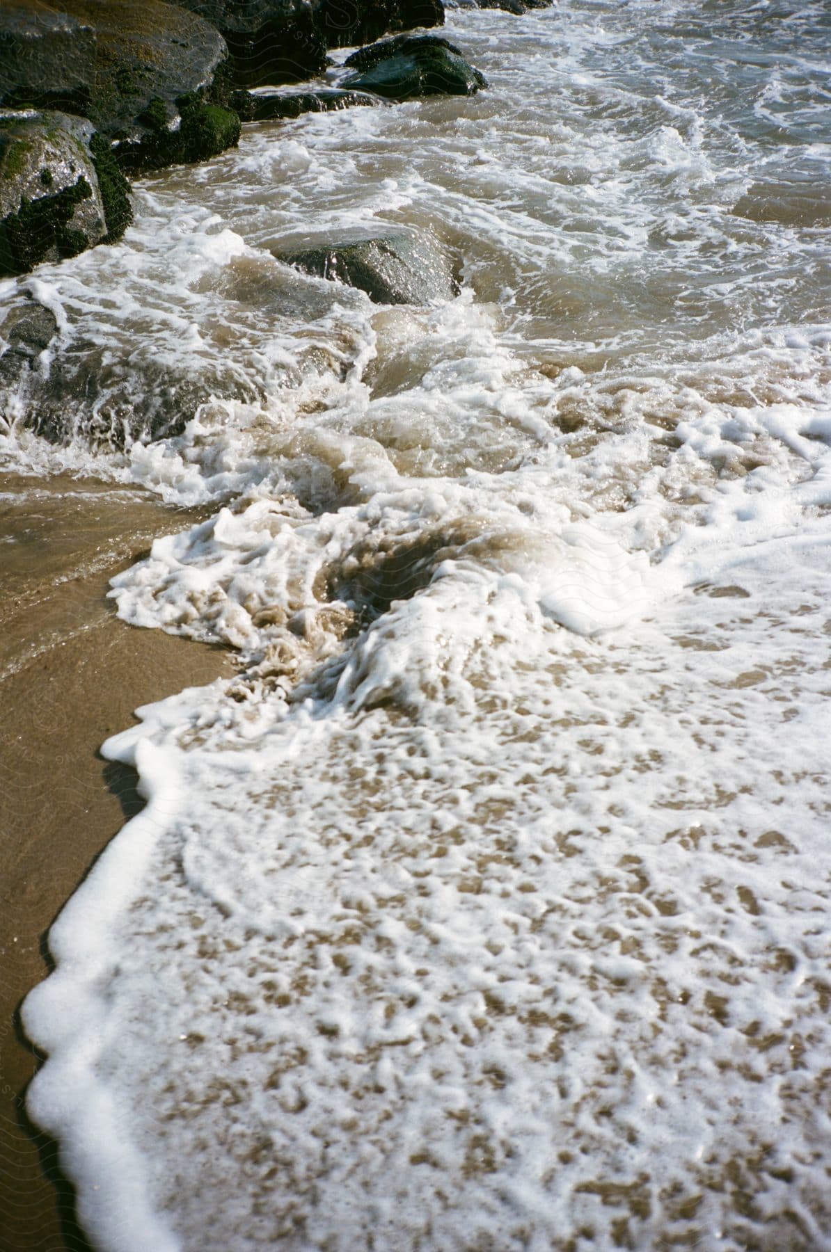 A serene beach scene with waves crashing against rocks