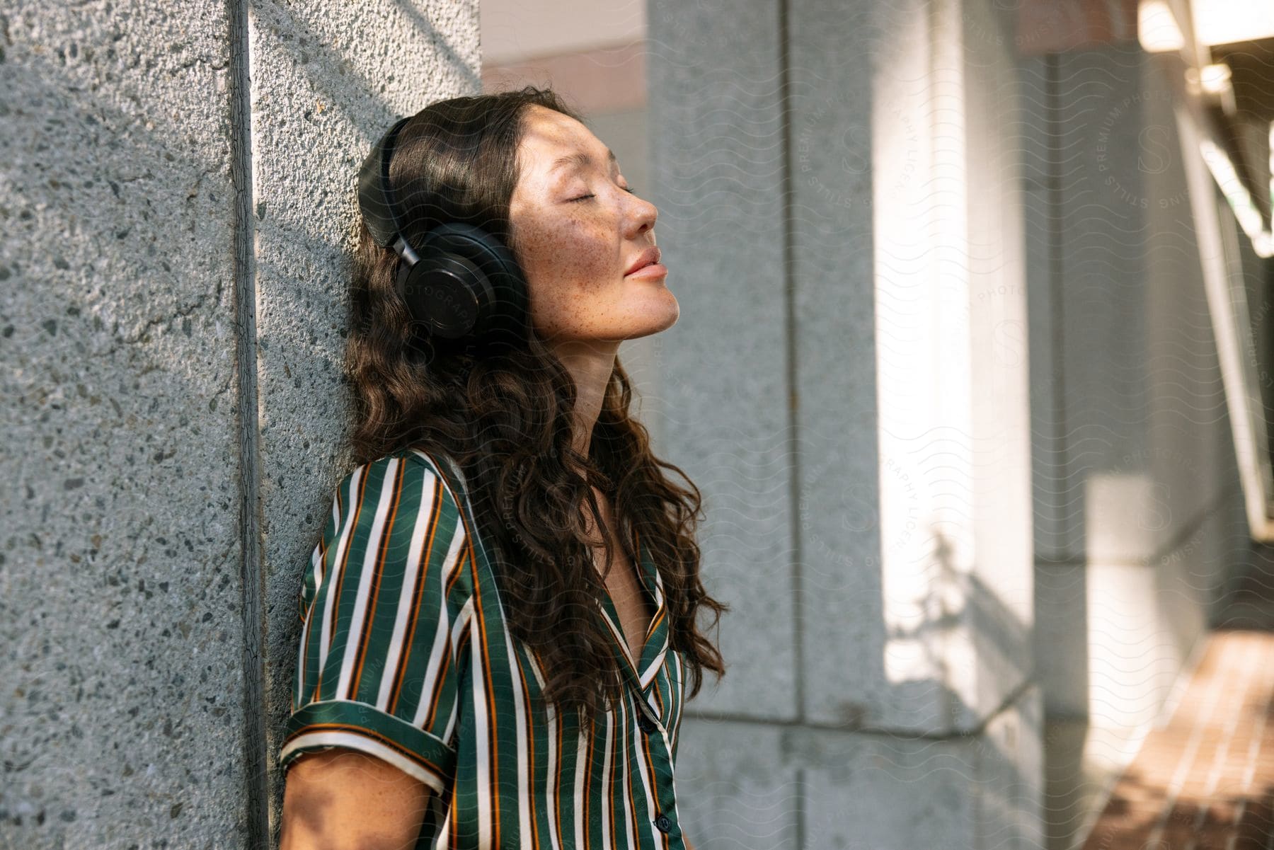 A person in los angeles unwinding and having fun wearing headphones and a happy expression