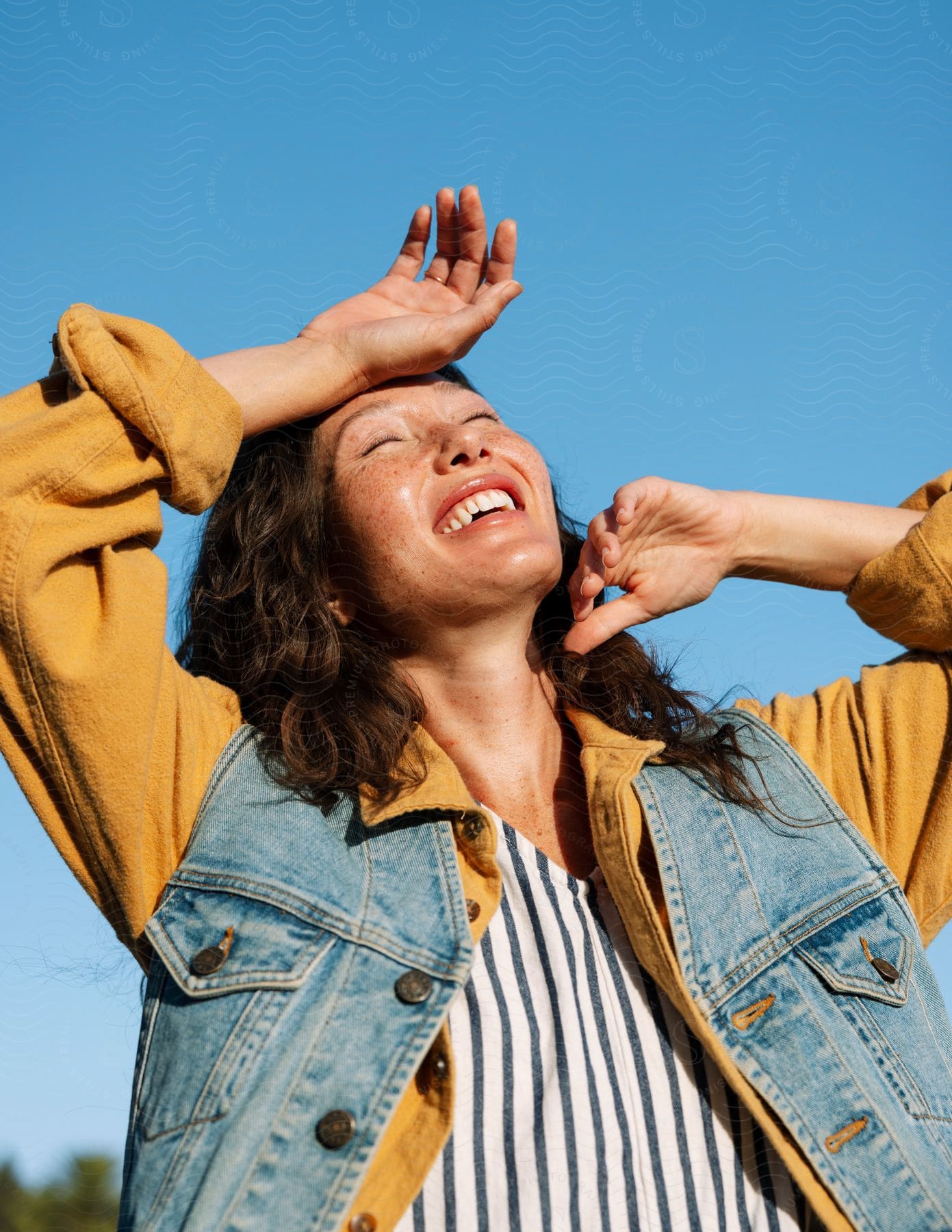 Stock photo of a smiling young woman feeling the sun on her face