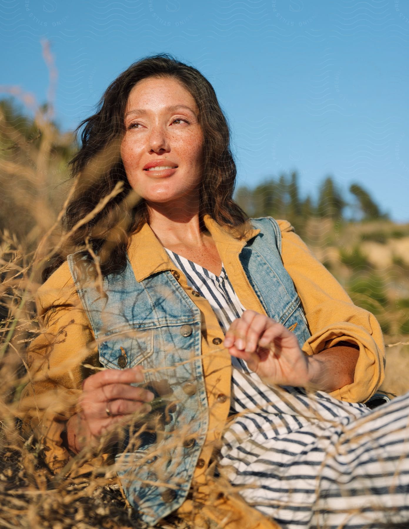 A woman laying in a field outdoors