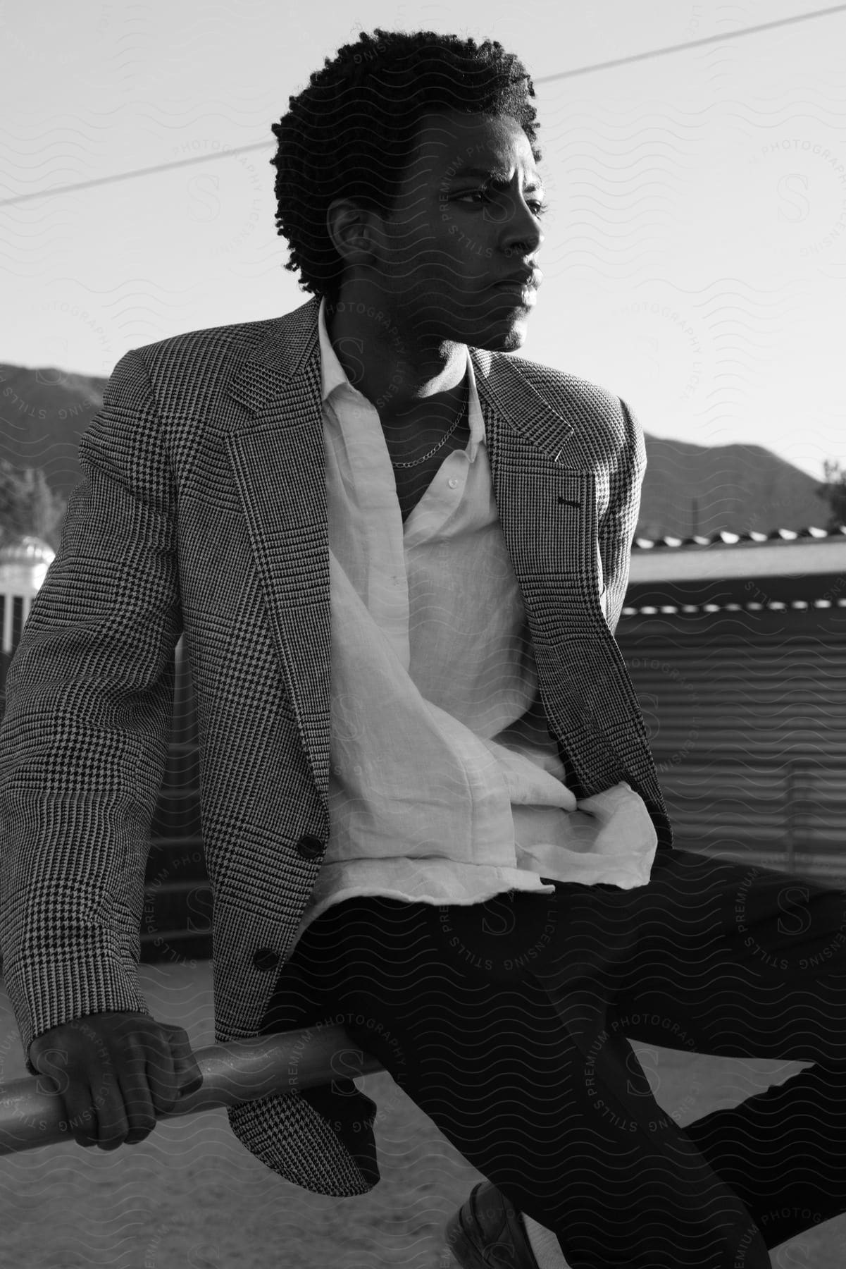 A Man Standing In The Desert Wearing A Formal Suit And Cool Hairstyle