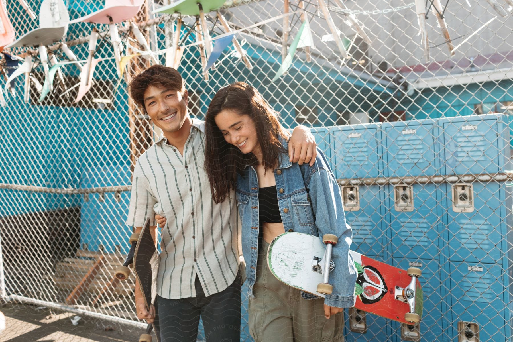 Two people excited and happy standing in front of a wall with luggage and bags