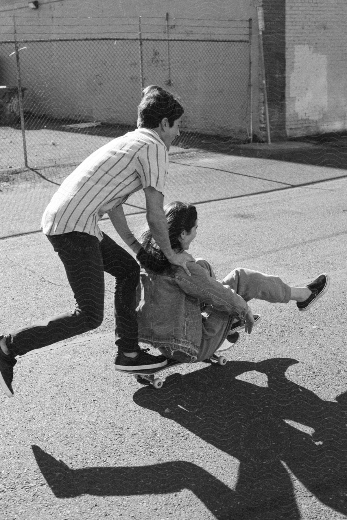 Young couple skateboard in the city street during the daytime