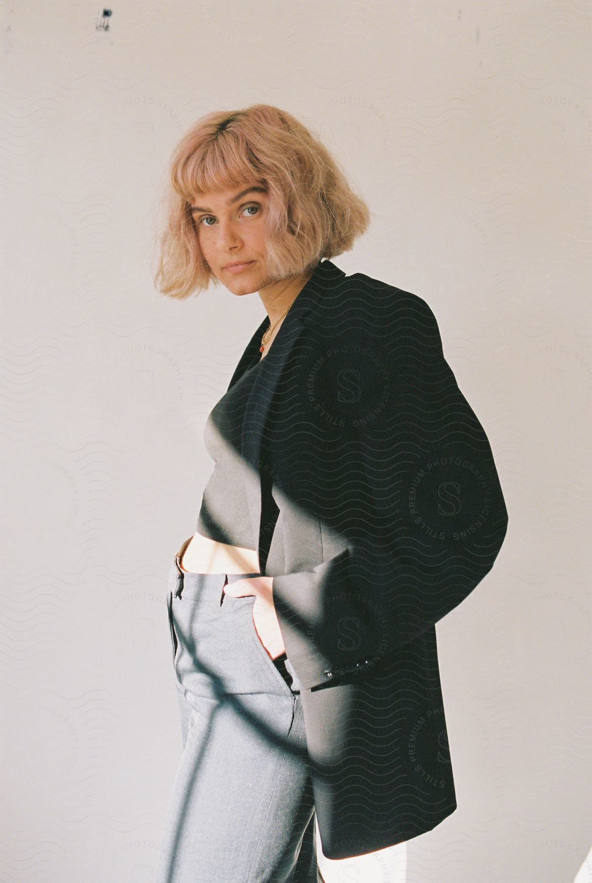 A blondehaired female model poses for the camera wearing a blazer with no expression