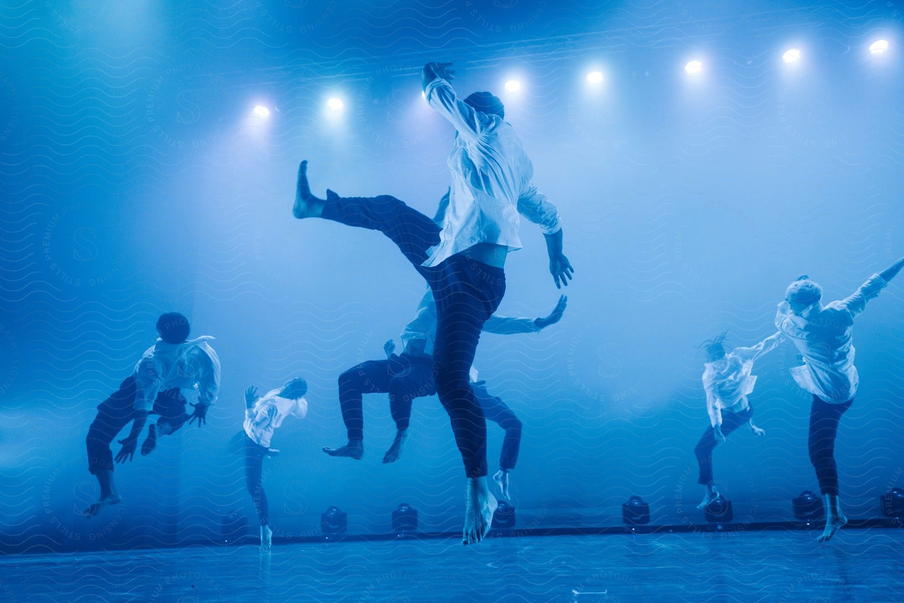 A small group of adults performing a dance routine