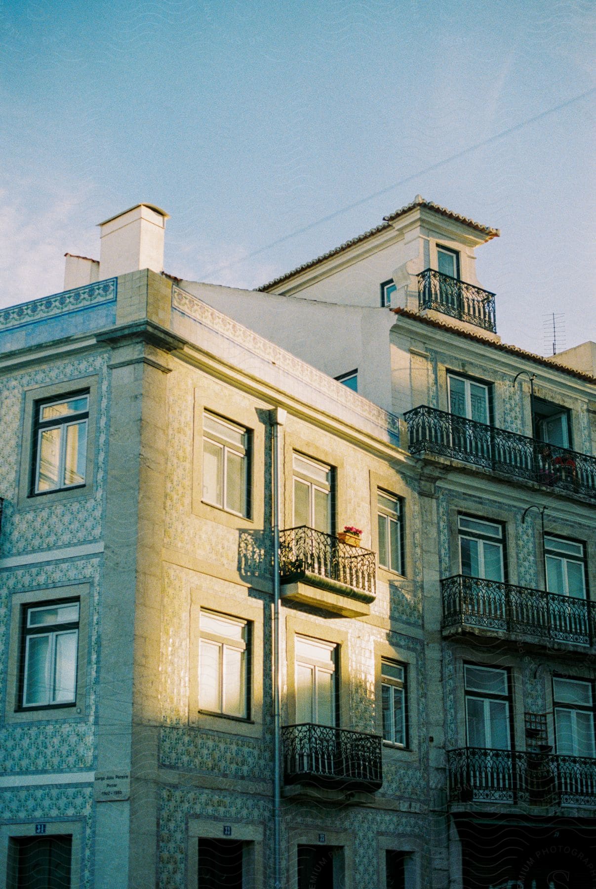 A sunny day illuminates a multistory building with balconies