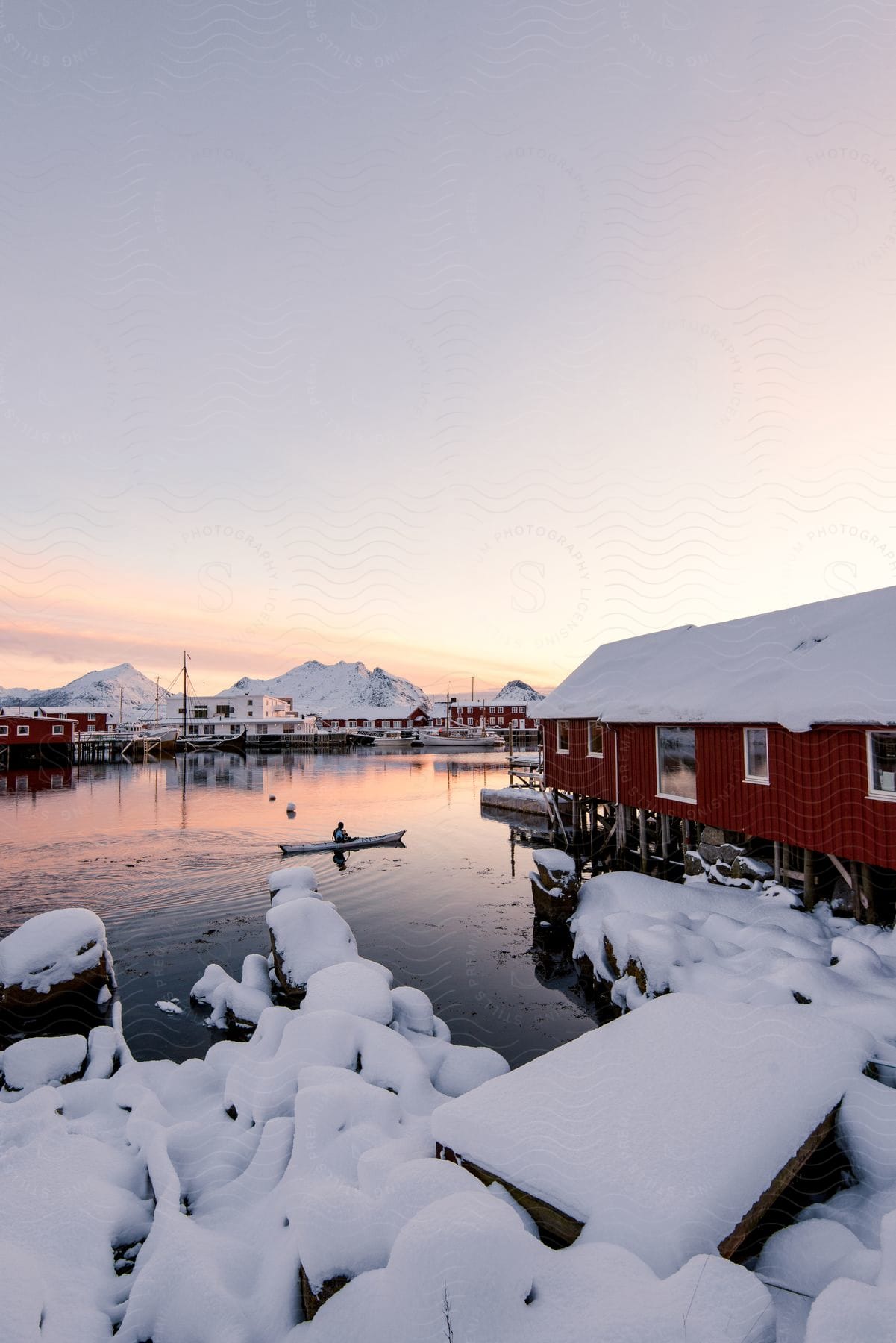 Waterfront red houses near a lake at sunset in norway