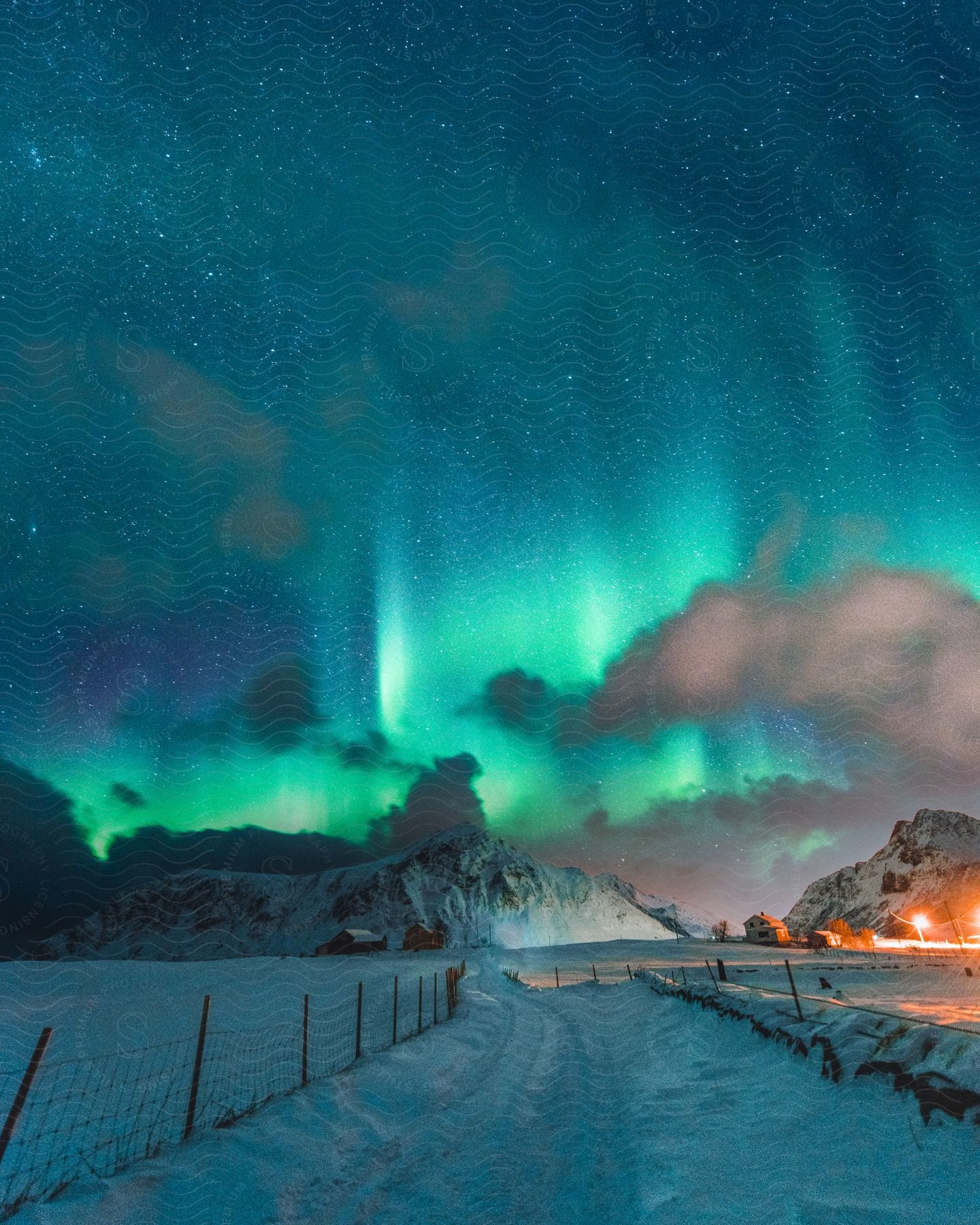 A frozen night sky with natural aurora lights illuminating the landscape