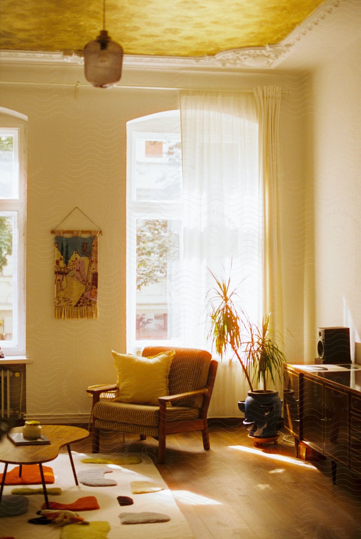 A living room with various furniture items such as a chair pillow rug and other decor