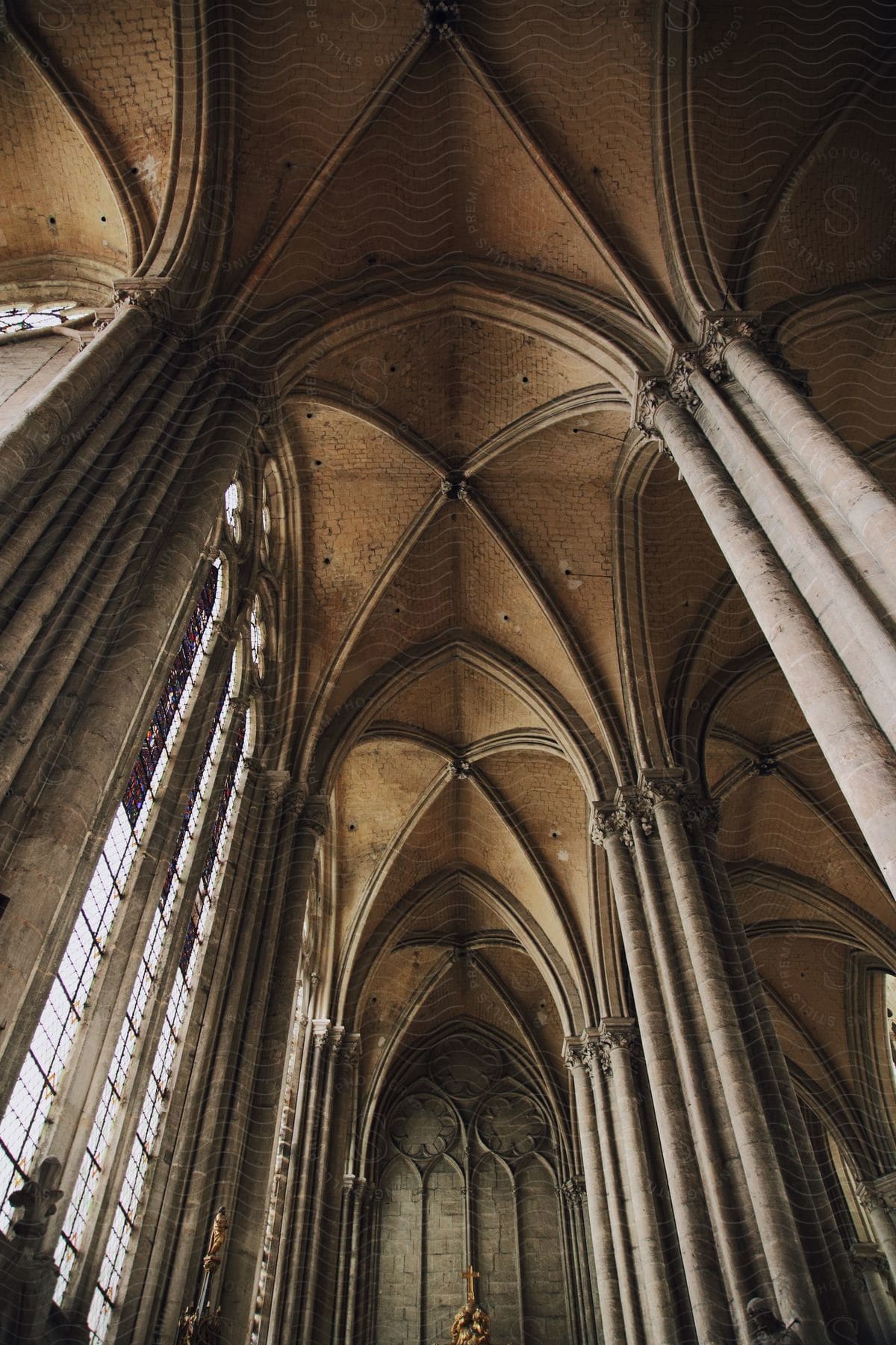 Vaulted ceilings and tall windows in an ancient cathedral in the daytime