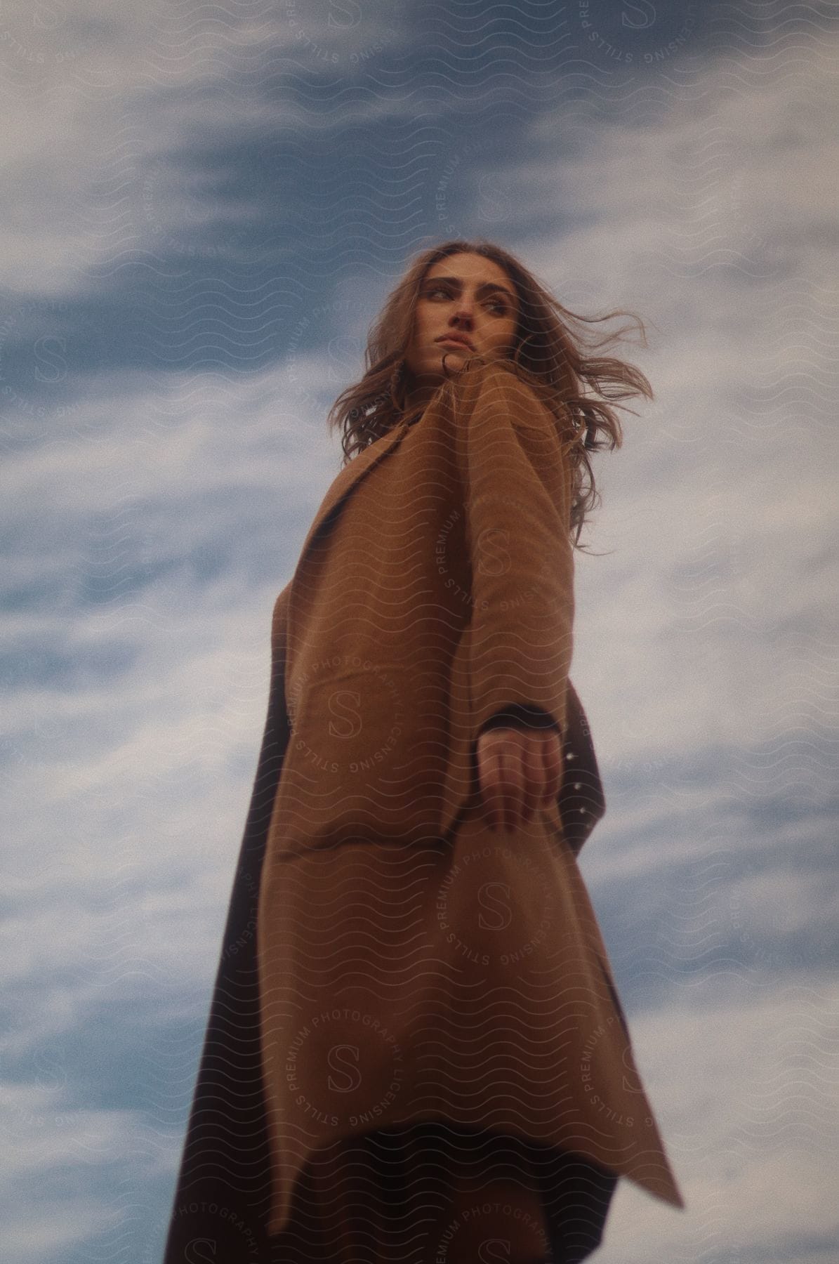 A woman standing outside on a cloudy day