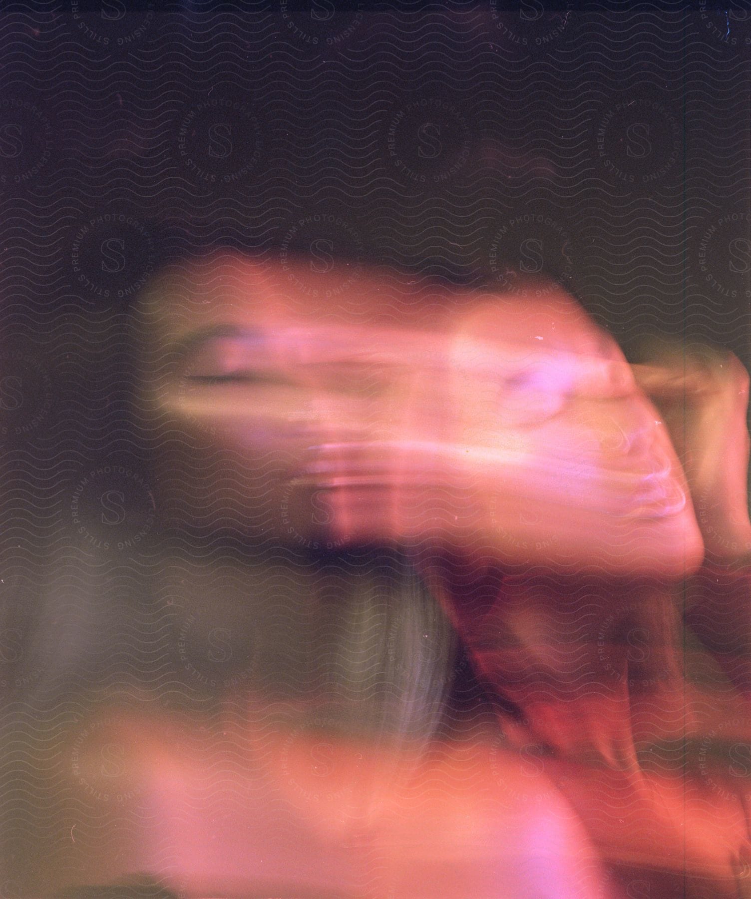 Blurred closeup of a young womans face with color trails