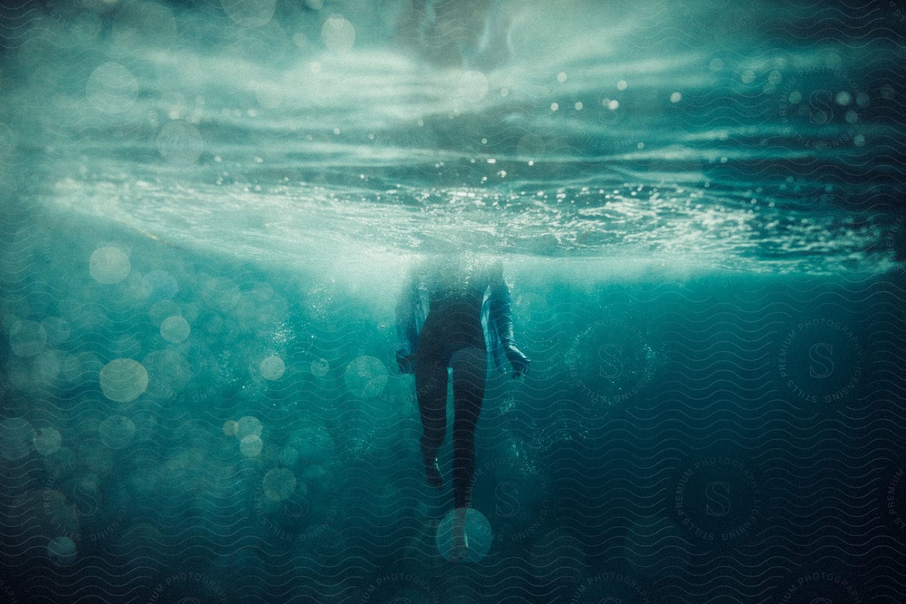 A person treading water under the surface