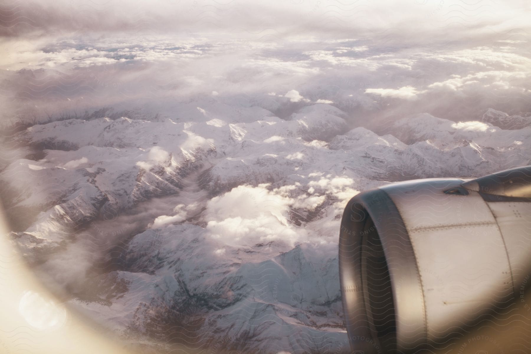 Snowy mountain range seen from a plane window