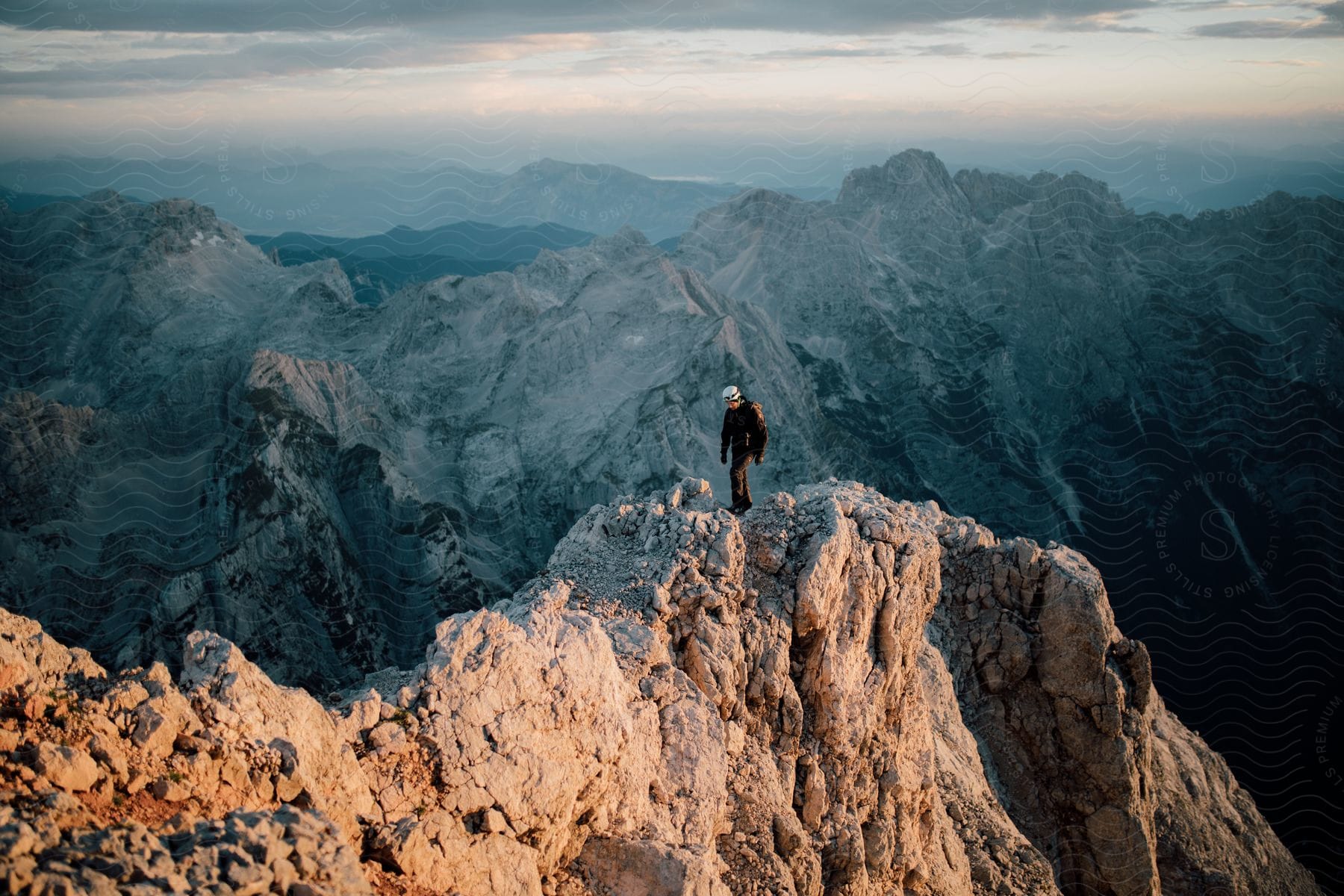 A man stands on top of a mountain in the european alps