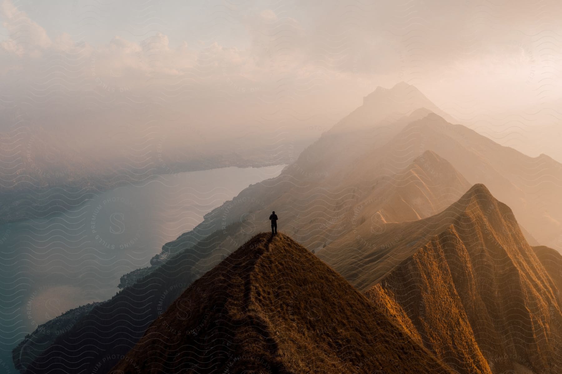 A person is hiking up a mountainous landscape in the european alps