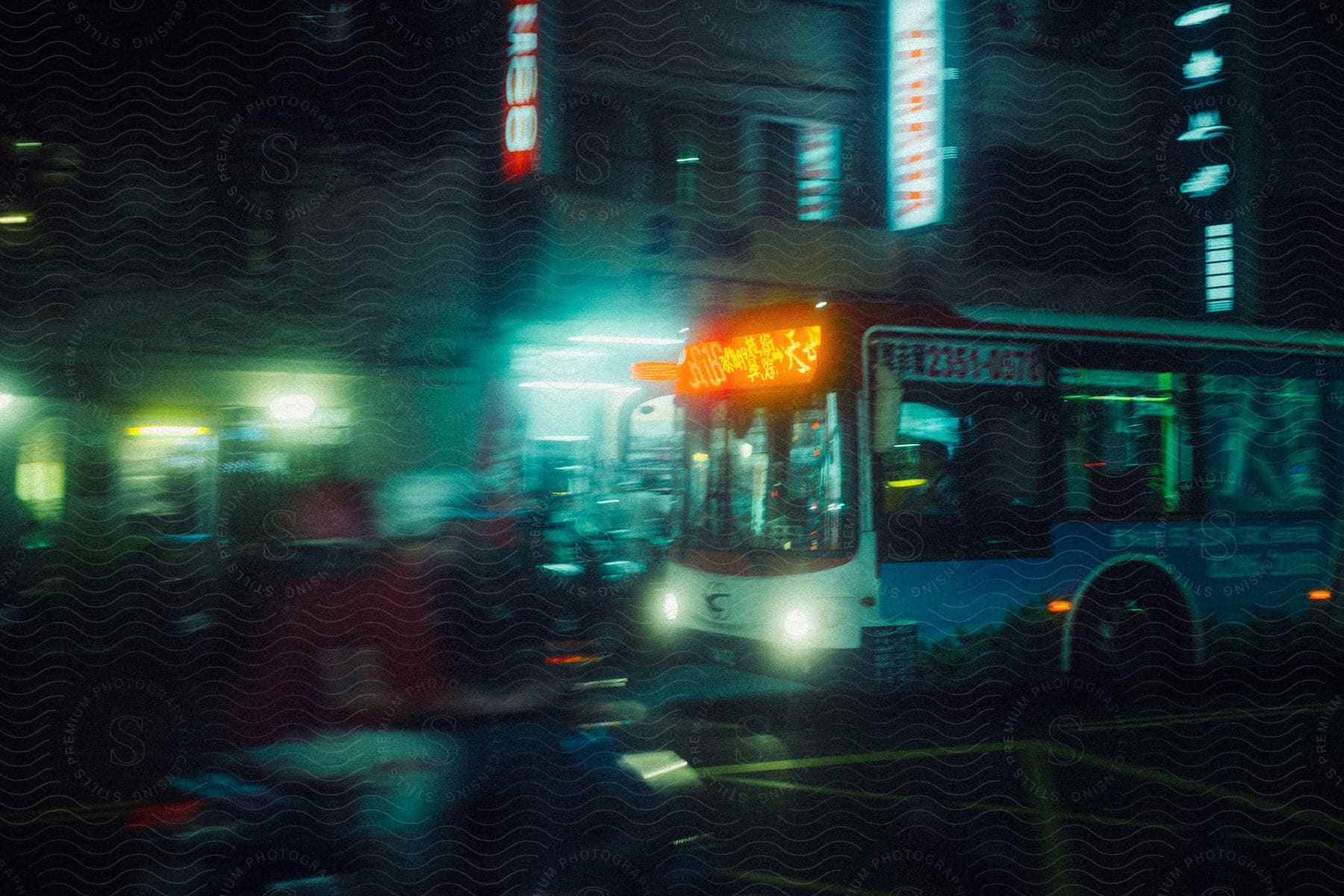 A cityscape of taiwan at night with buildings cars and buses