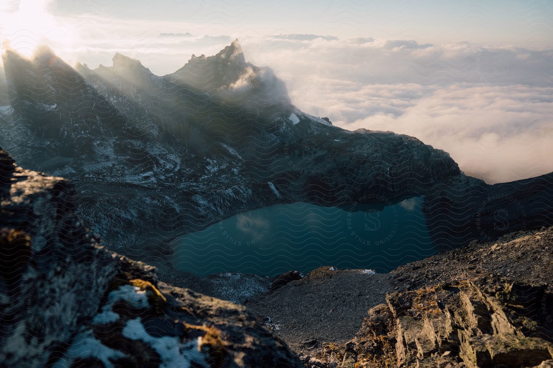 Sunlit Snowy Mountain Peaks And A Lake In The Wilderness