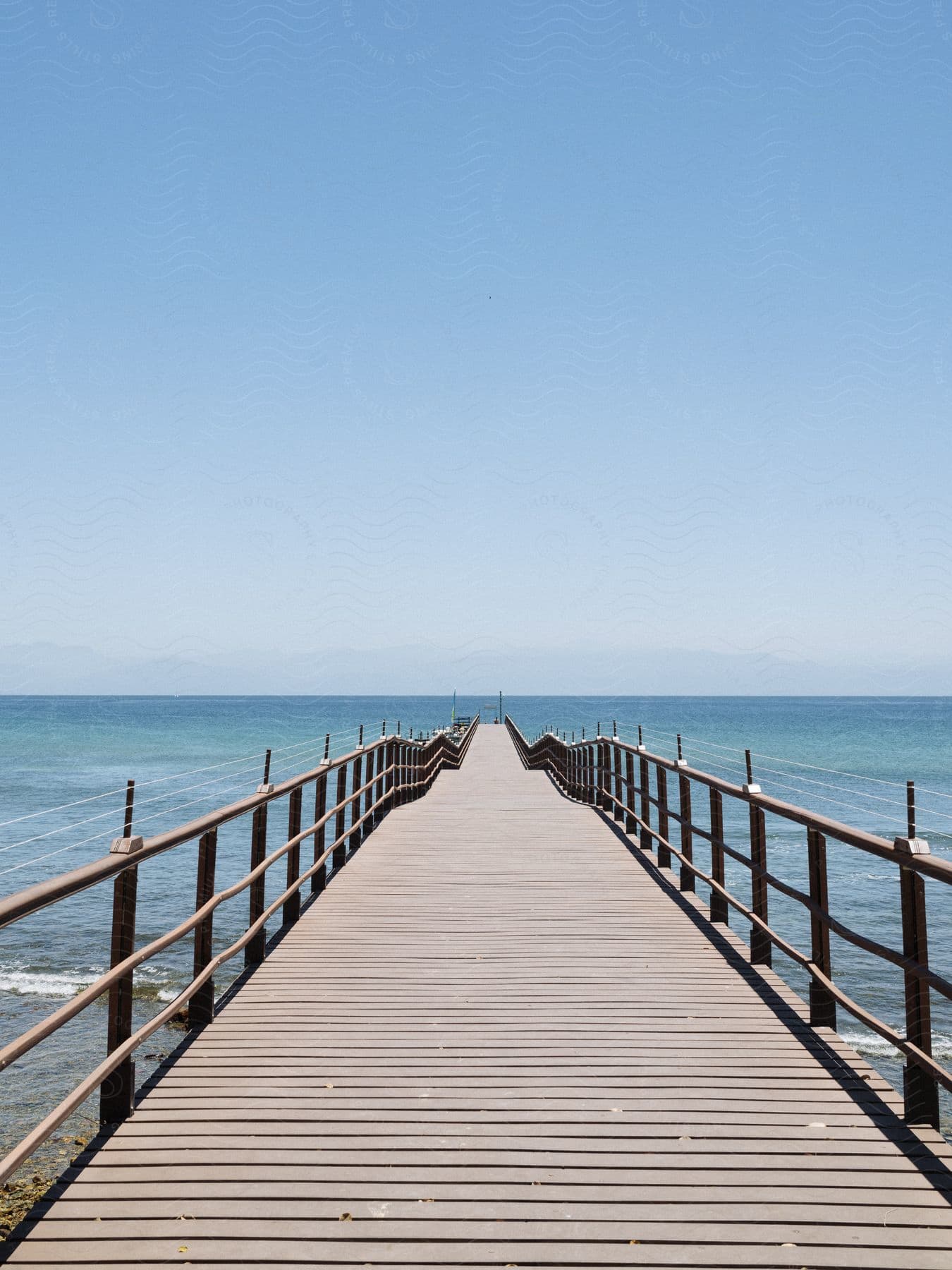 A long pier extending over a beach