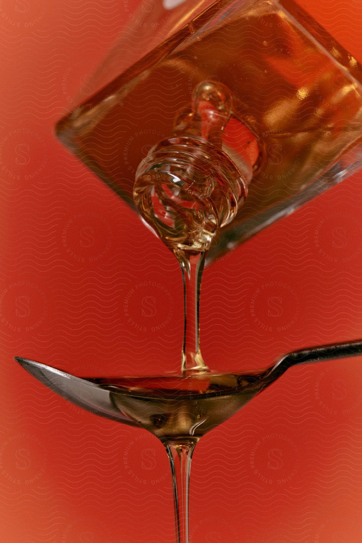 A beverage being poured into a spoon on a tableware