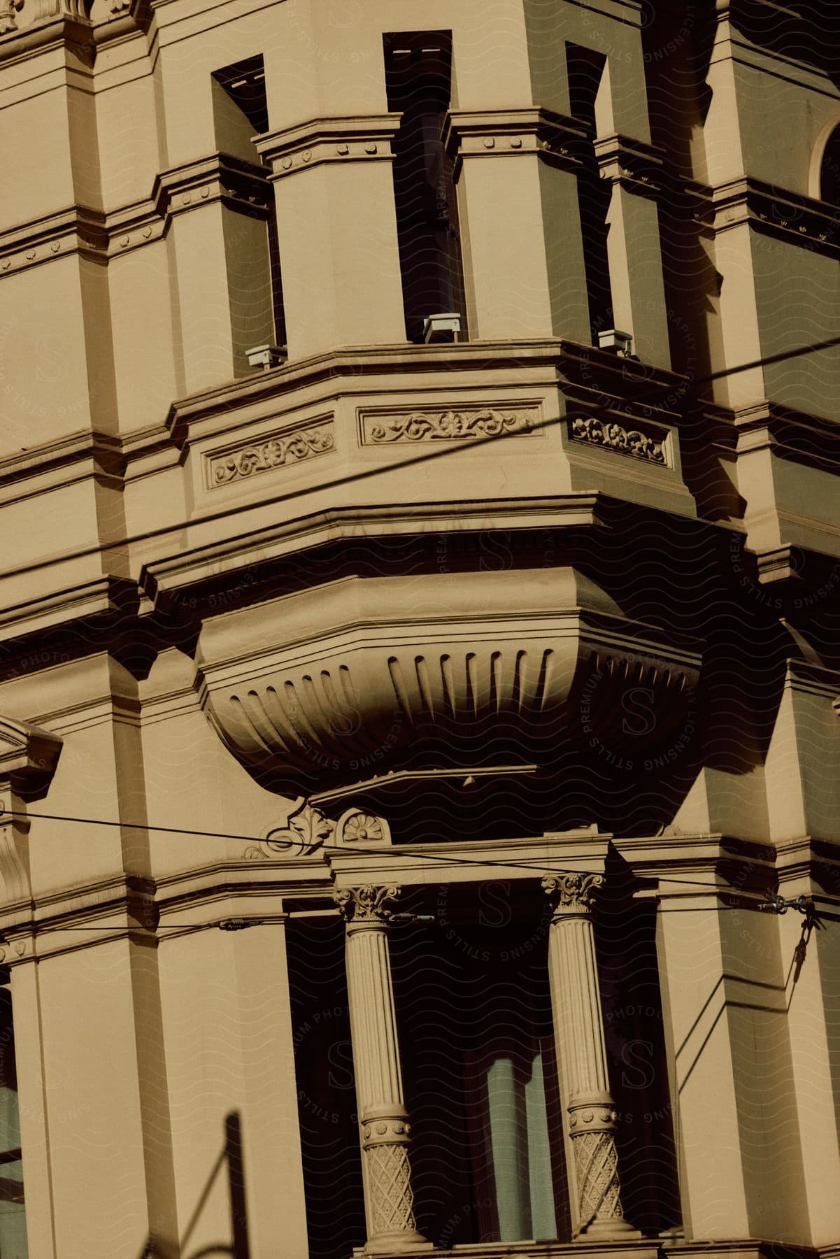 Detail of a building showcasing a window with columns and sculptured relief