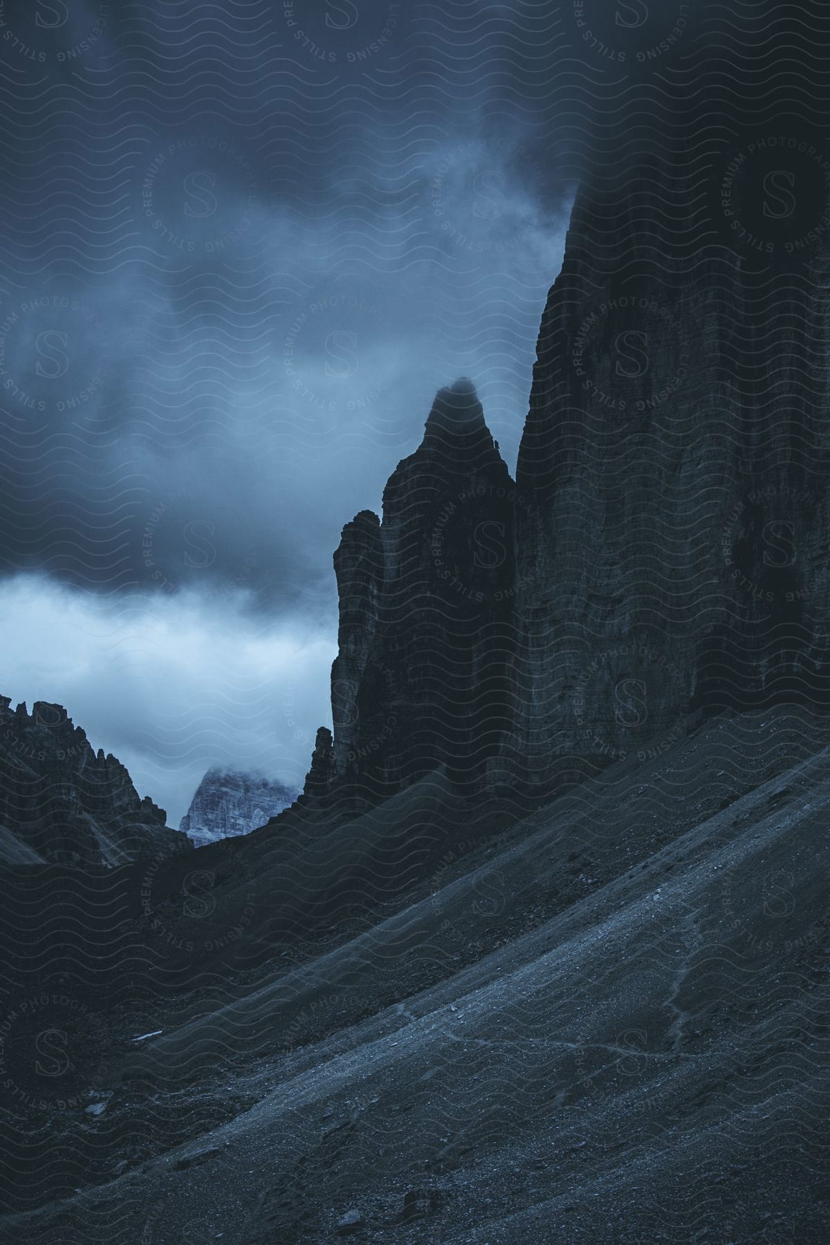 Mountains and rock formations under dark clouds in the sky