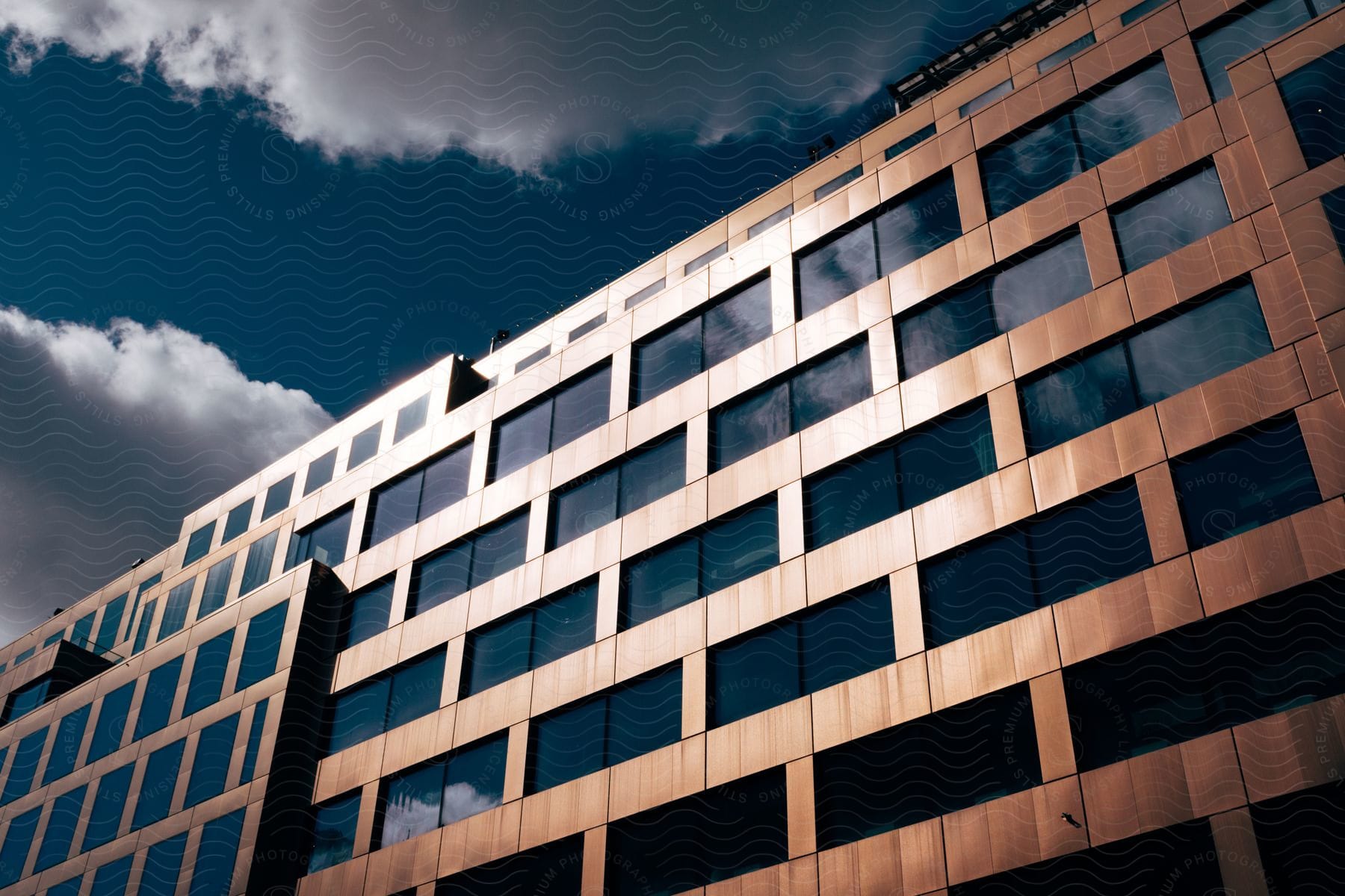 A building reflecting the setting sun in an urban setting at dusk