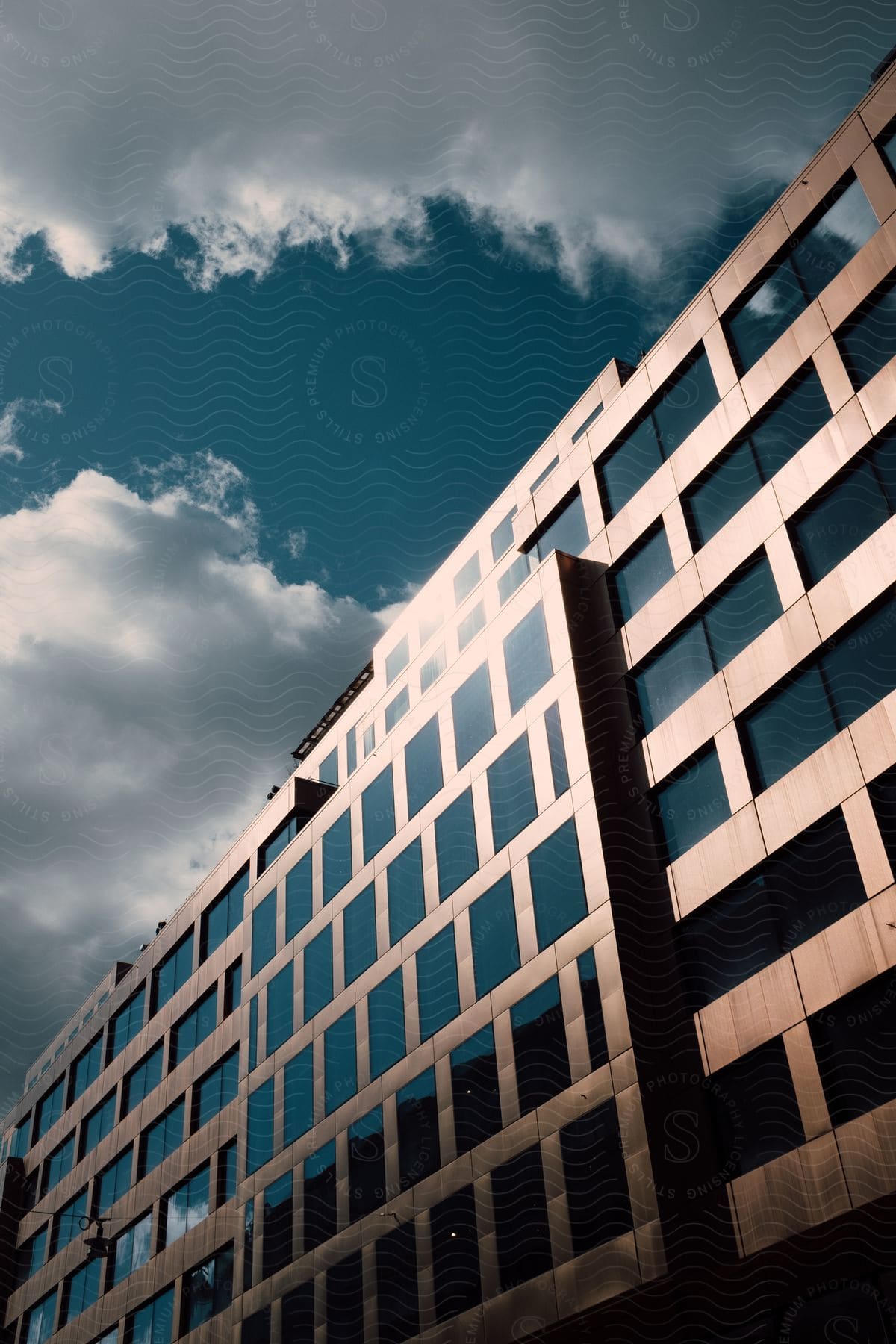 A large modern office building on a partly cloudy day