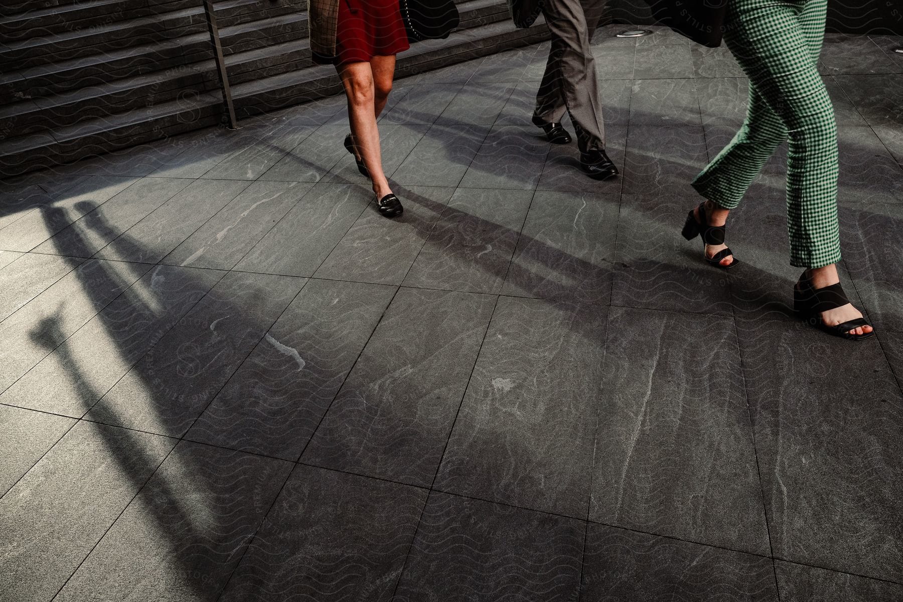 Three people are walking outdoors together