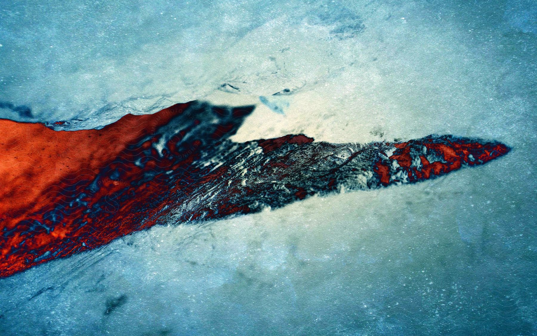 A cracked red ice formation in a natural outdoor setting