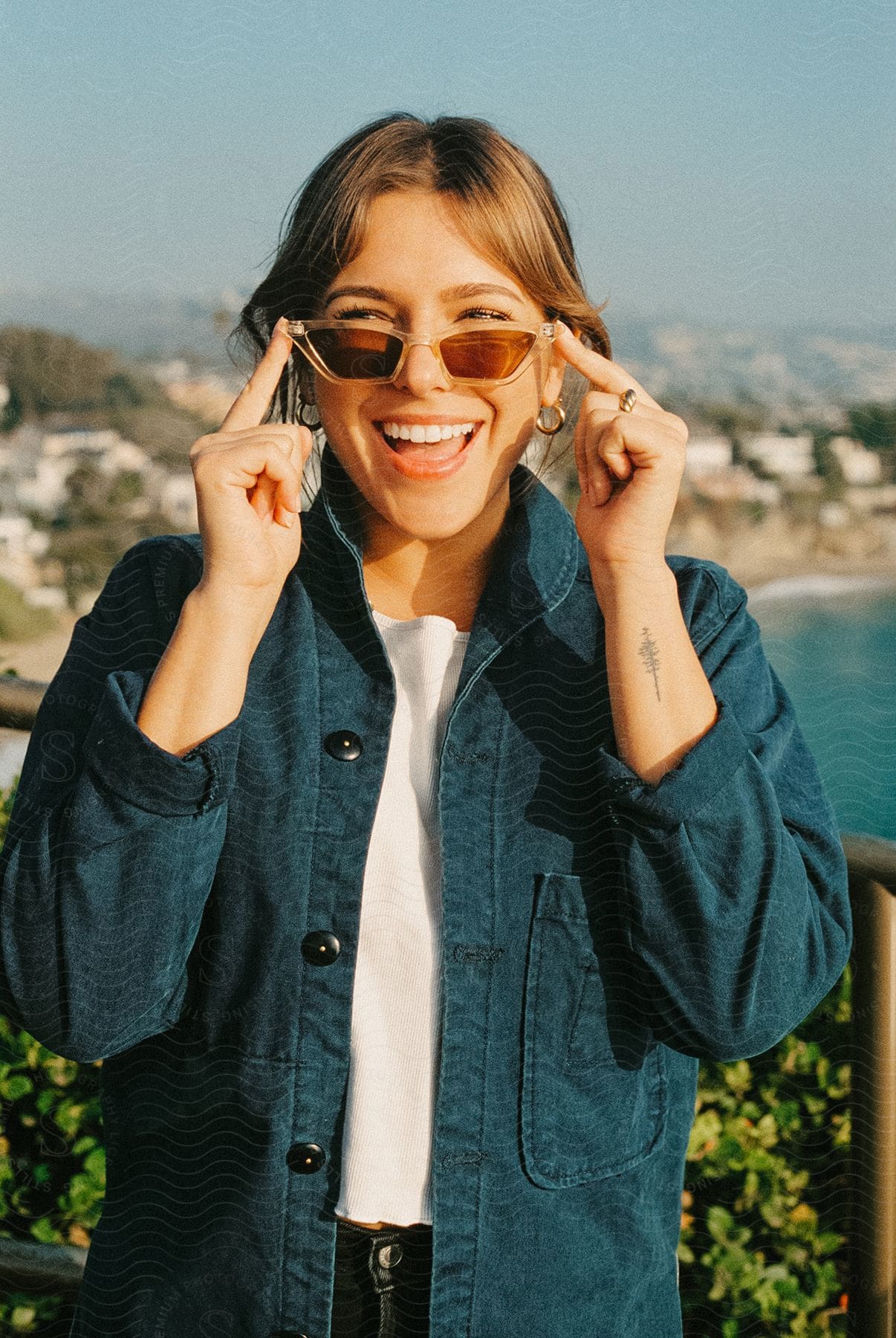 Smiling woman wearing sunglasses with sunny landscape at the beach