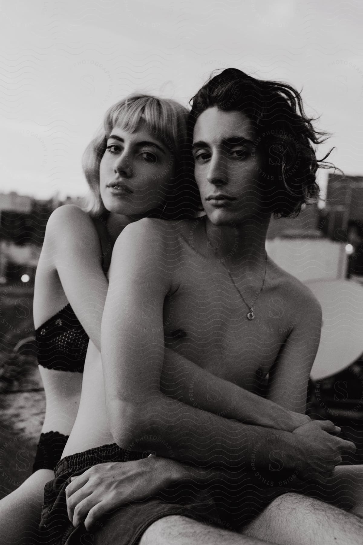 Two people standing at night in brooklyn wearing swimwear and accessories