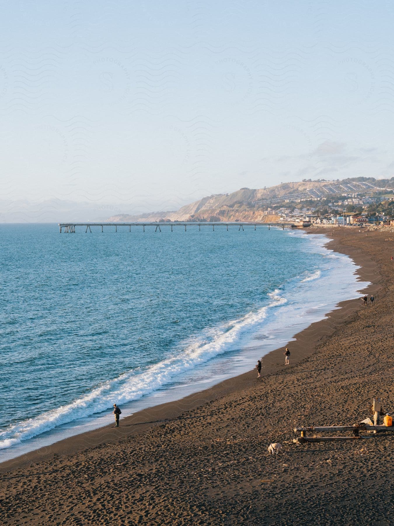 A sandy beach next to a small coastal town