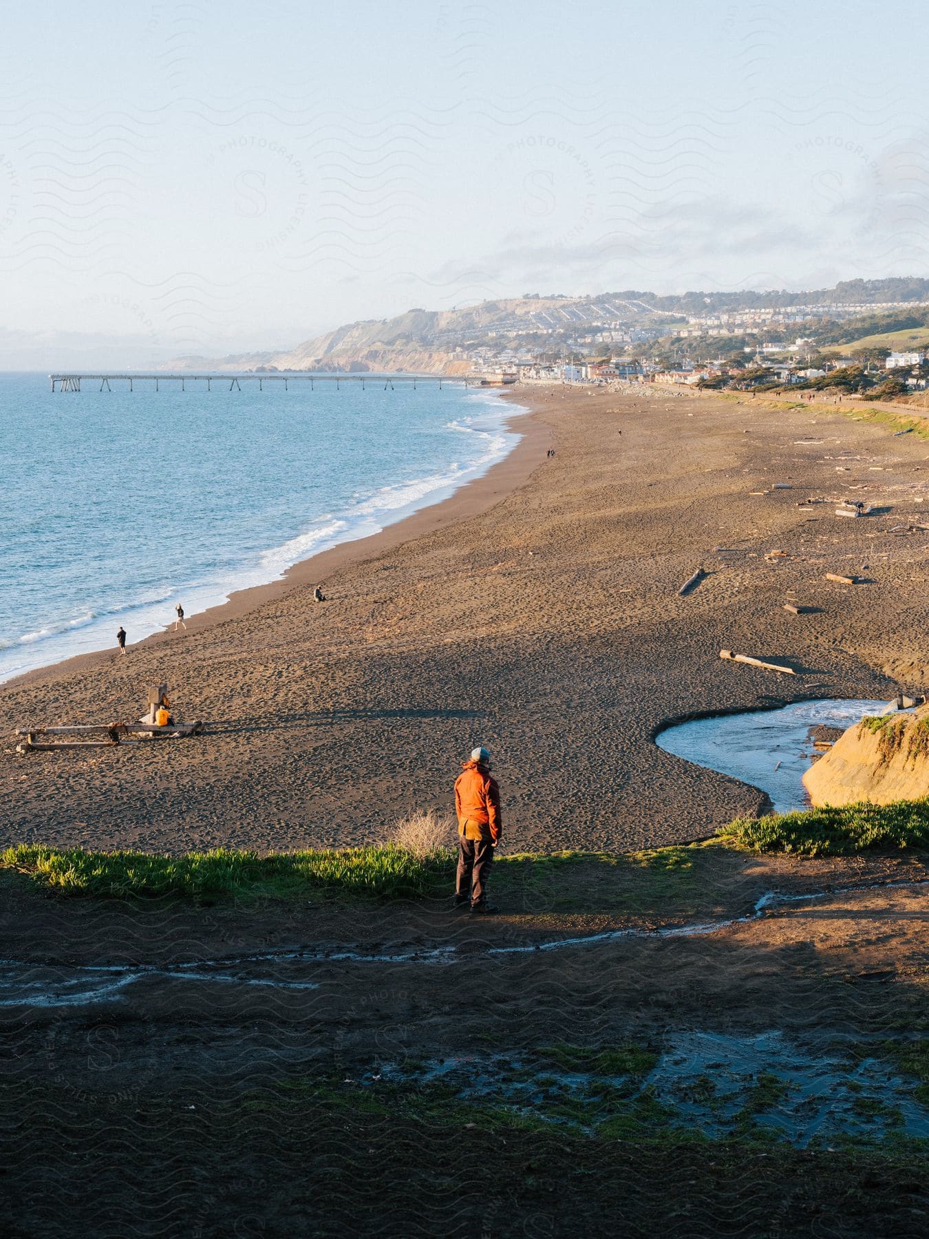 People enjoying the beach in summer at mori point during sunset