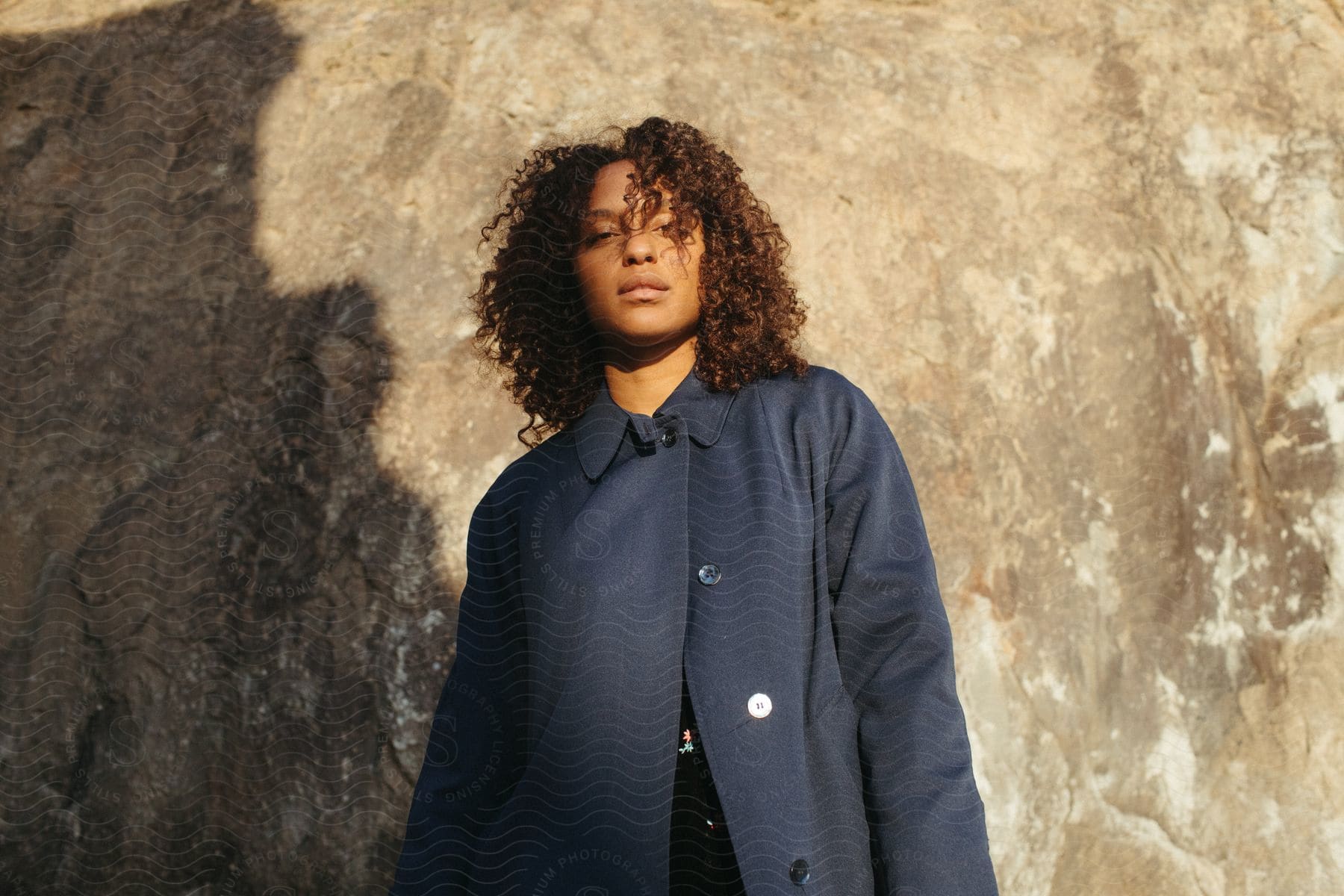 A woman standing outdoors wearing a jacket