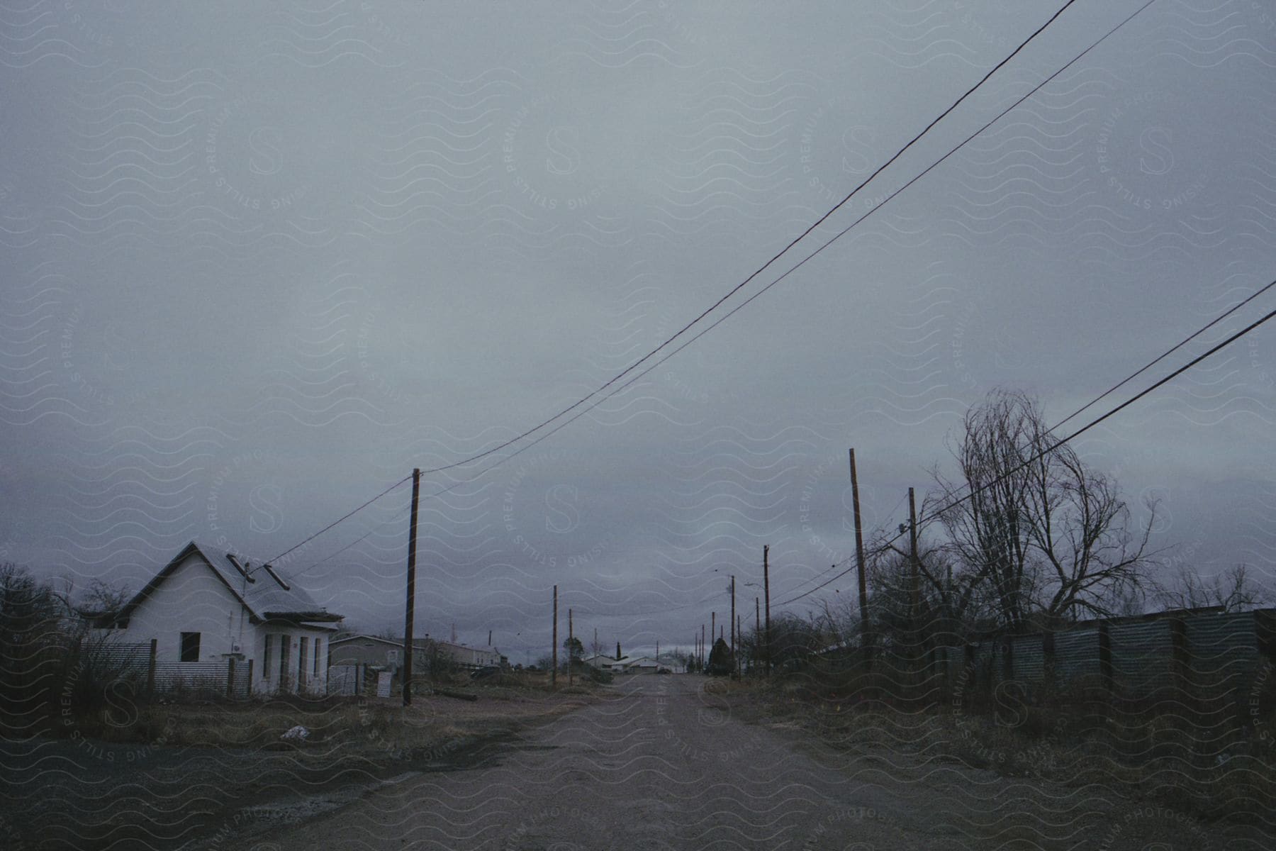 A rural region with small houses dirt roads and low vegetation