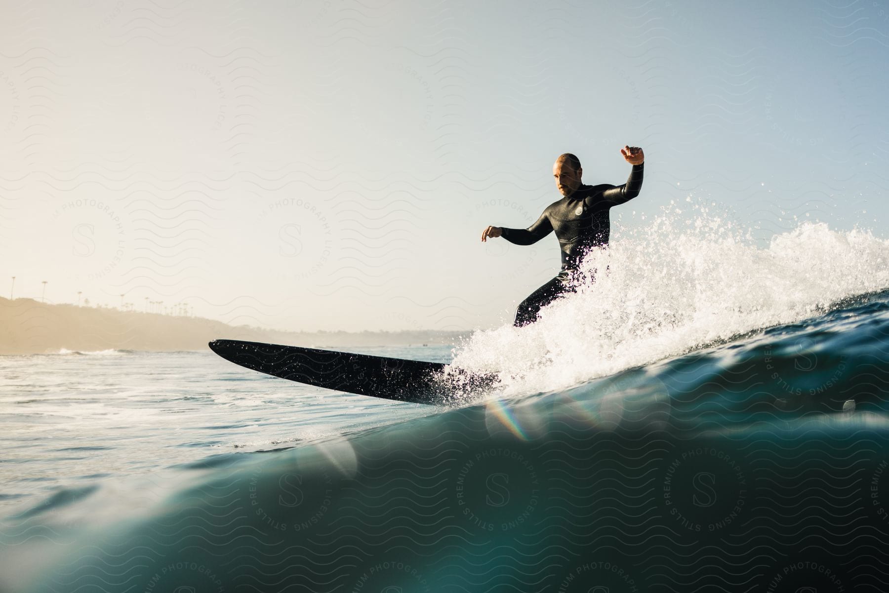 A man surfing a wave with a longboard.