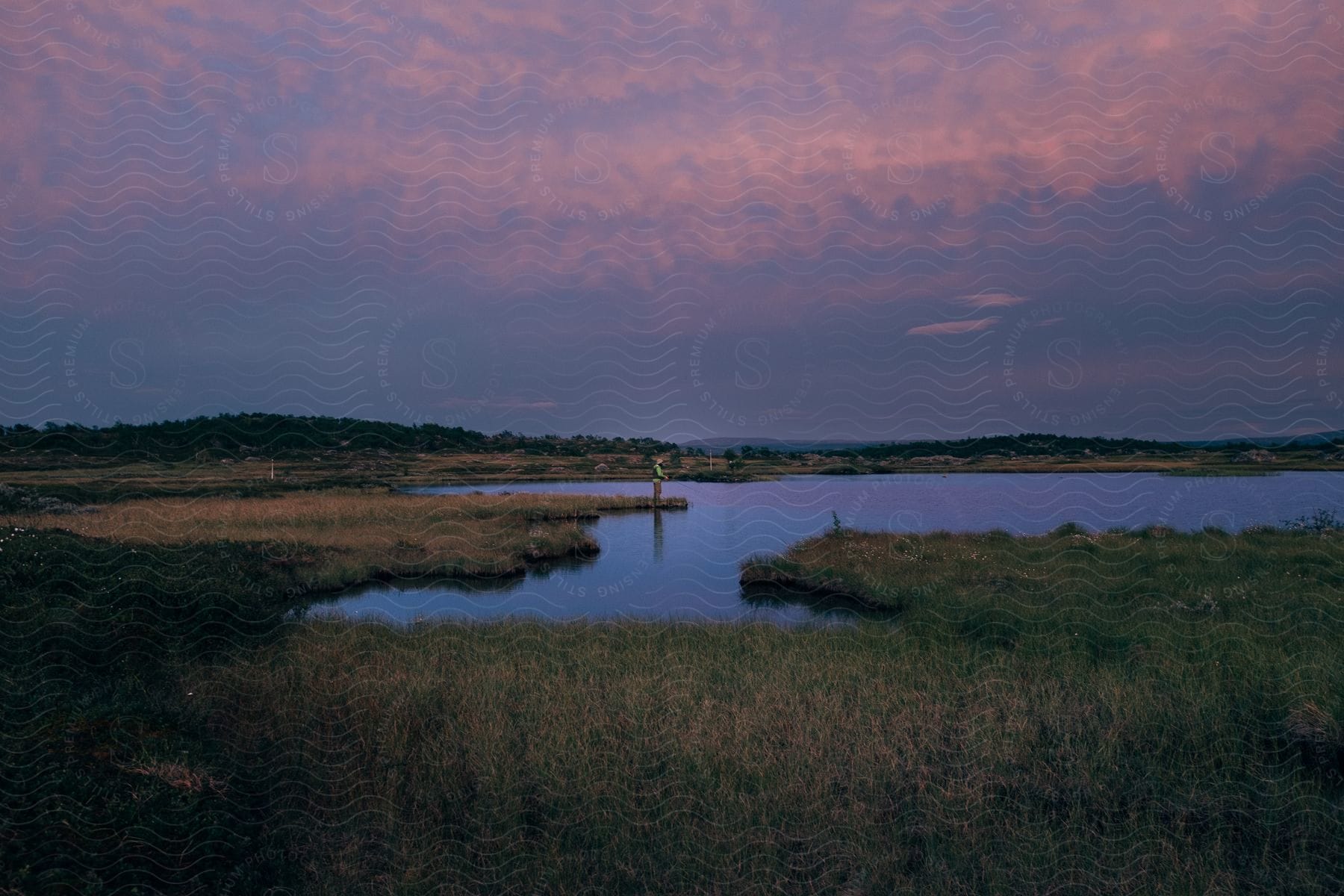 A man fishing in a coastal inlet