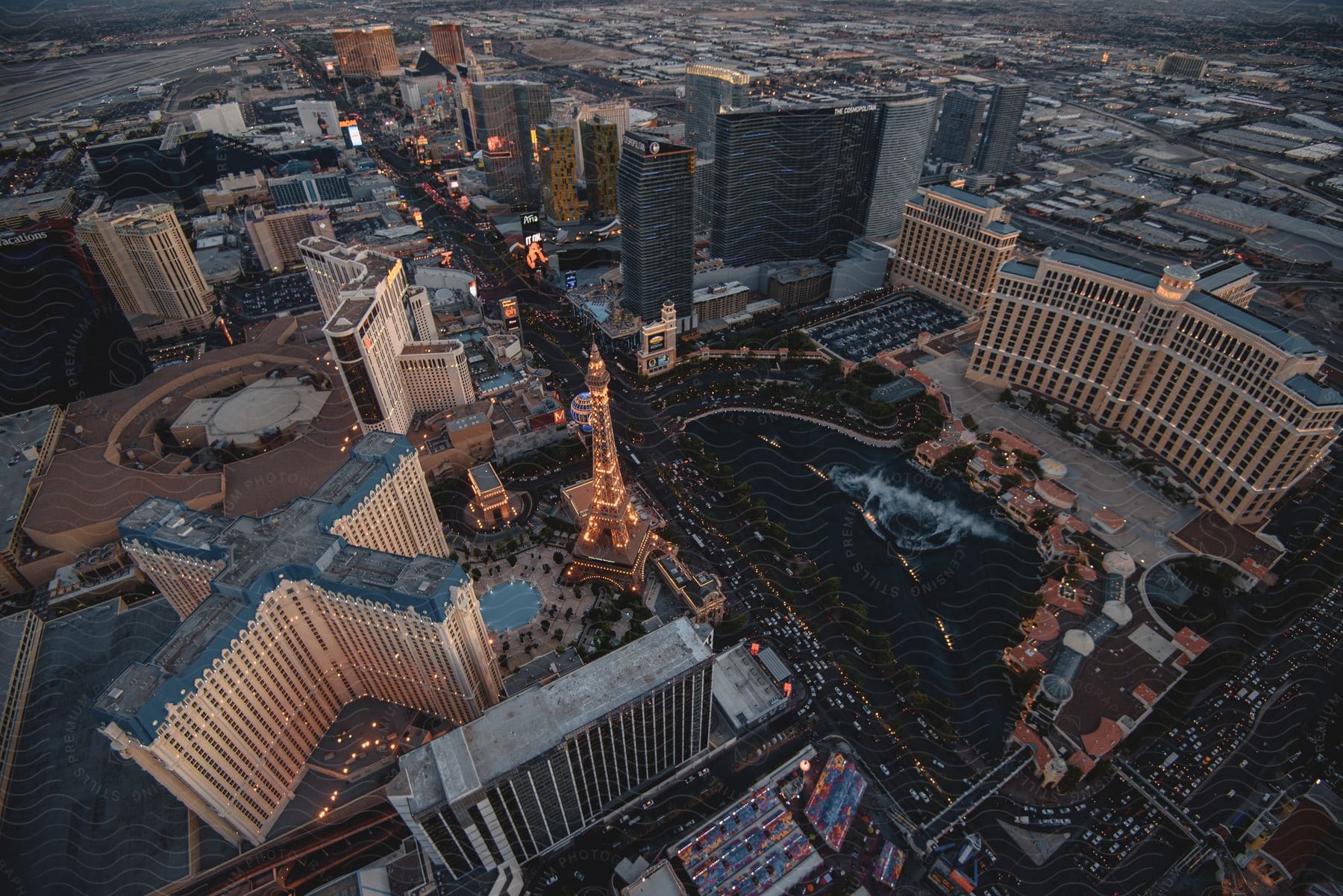 Aerial view of a cityscape at dusk with skyscrapers and a tower