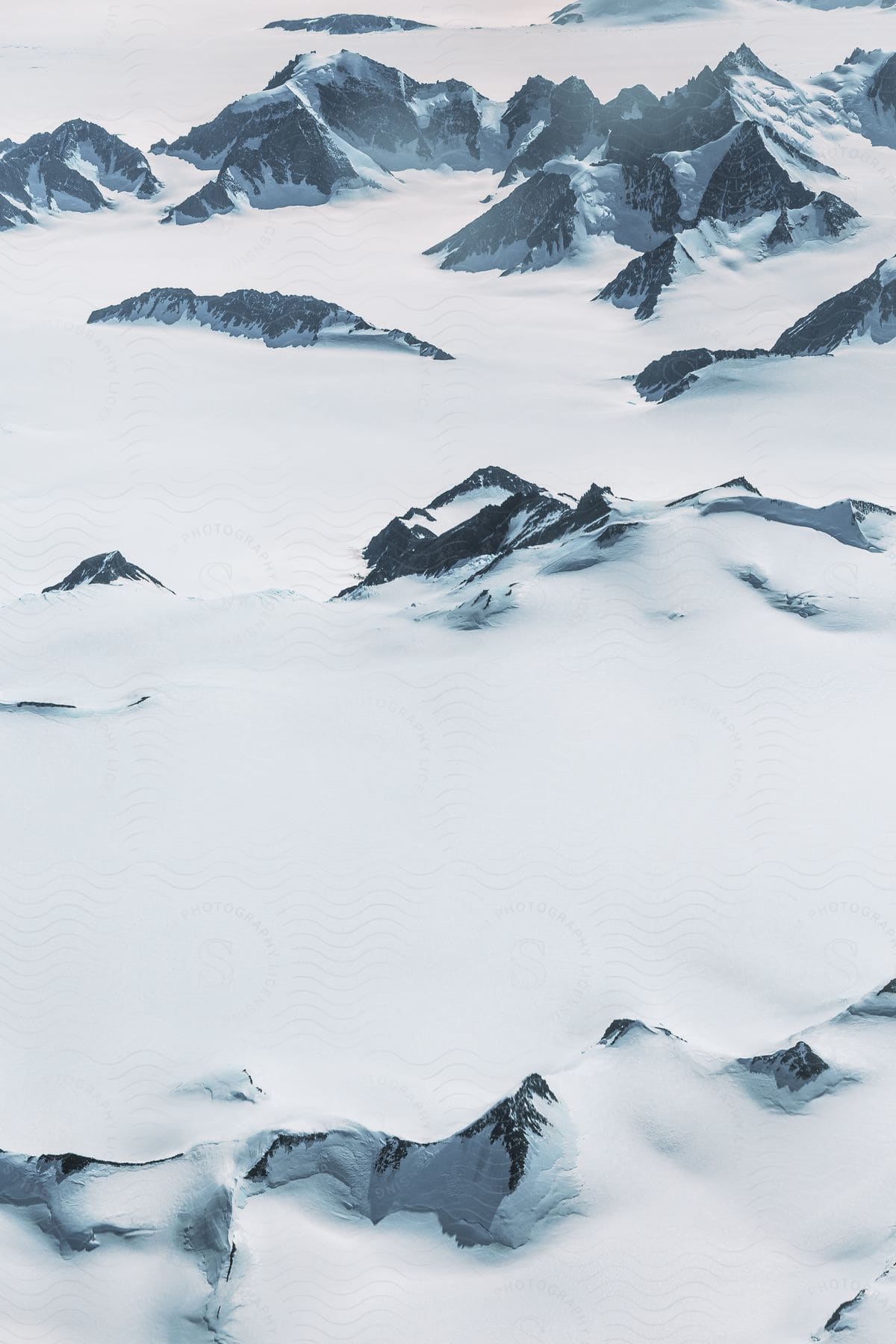 A snowy landscape of rocky terrain during the day in greenland